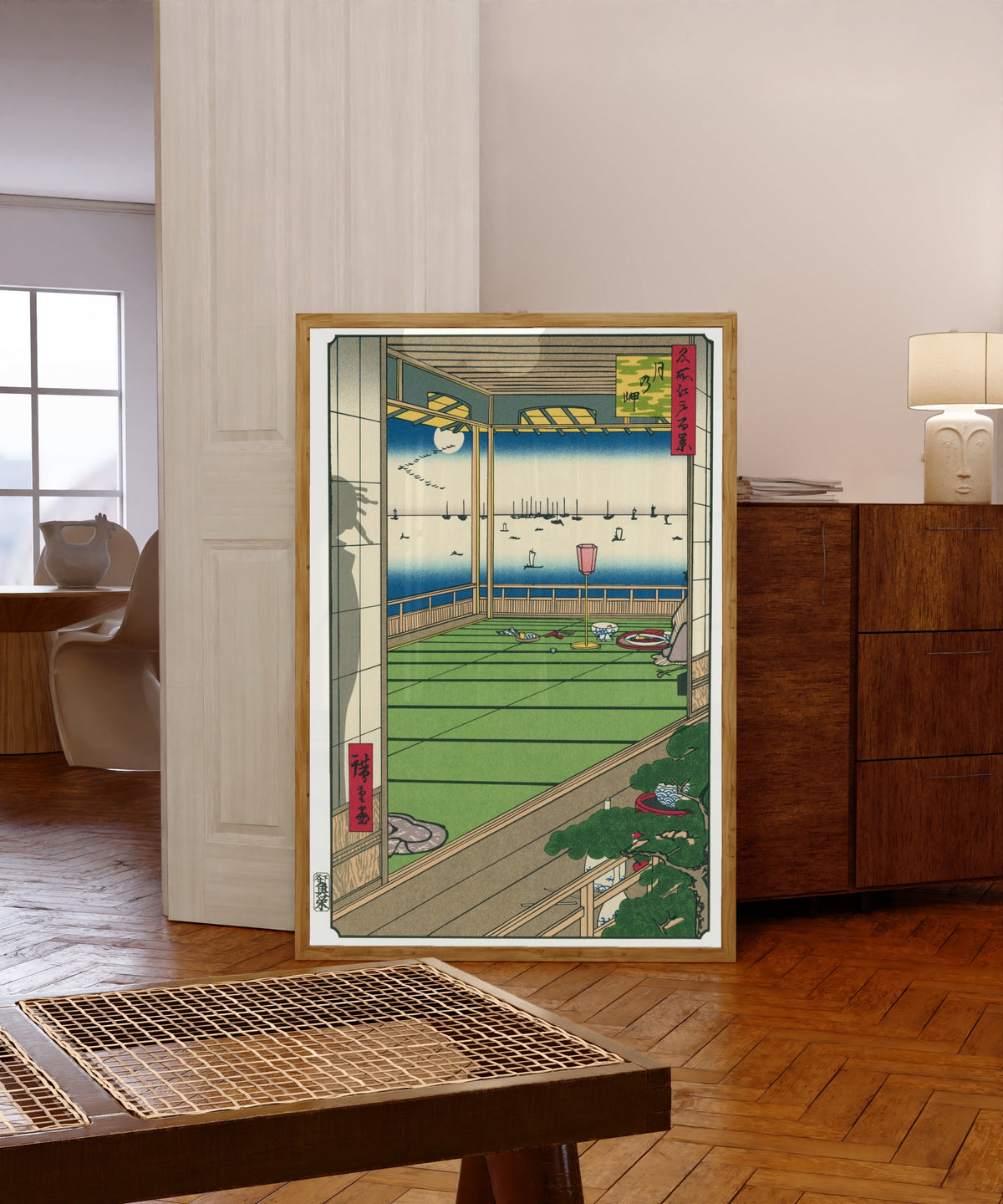 Framed art print of Moon Viewing by Utagawa Hiroshige, in a light wood frame leaning in a warm room with a parquet floor