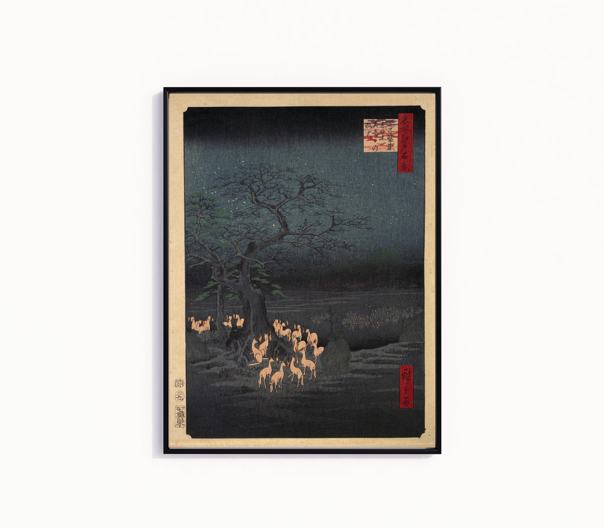 Framed art print of New Year's Eve Foxfire by Utagawa Hiroshige, in a slim black frame on a plain white wall
