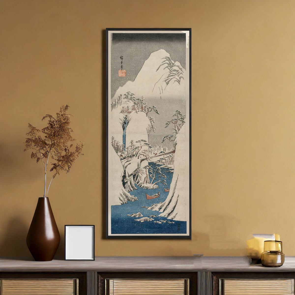 The Fuji River in the Snow by Utagawa Hiroshige — framed on an ochre wall above a console table