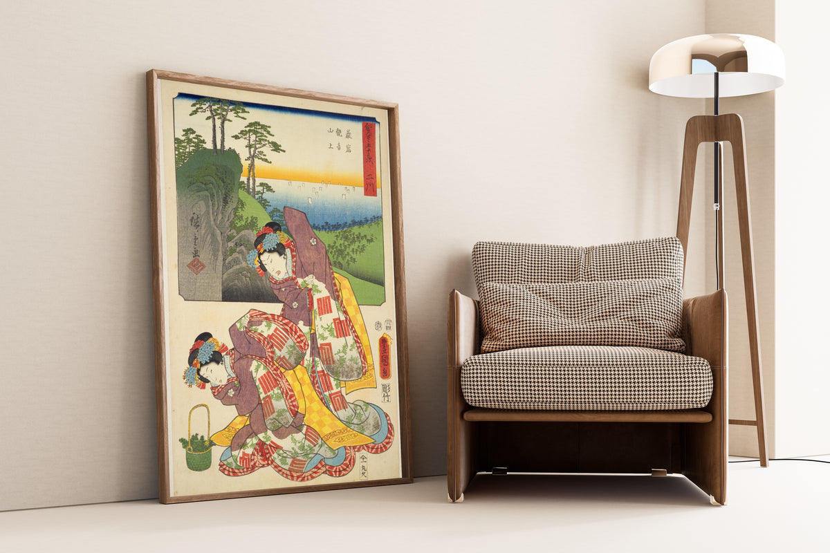 Fifty-three Stations by Two Brushes: Futagawa by Utagawa Hiroshige & Utagawa Kunisada — framed and leaning against a wall beside an armchair and a floor lamp