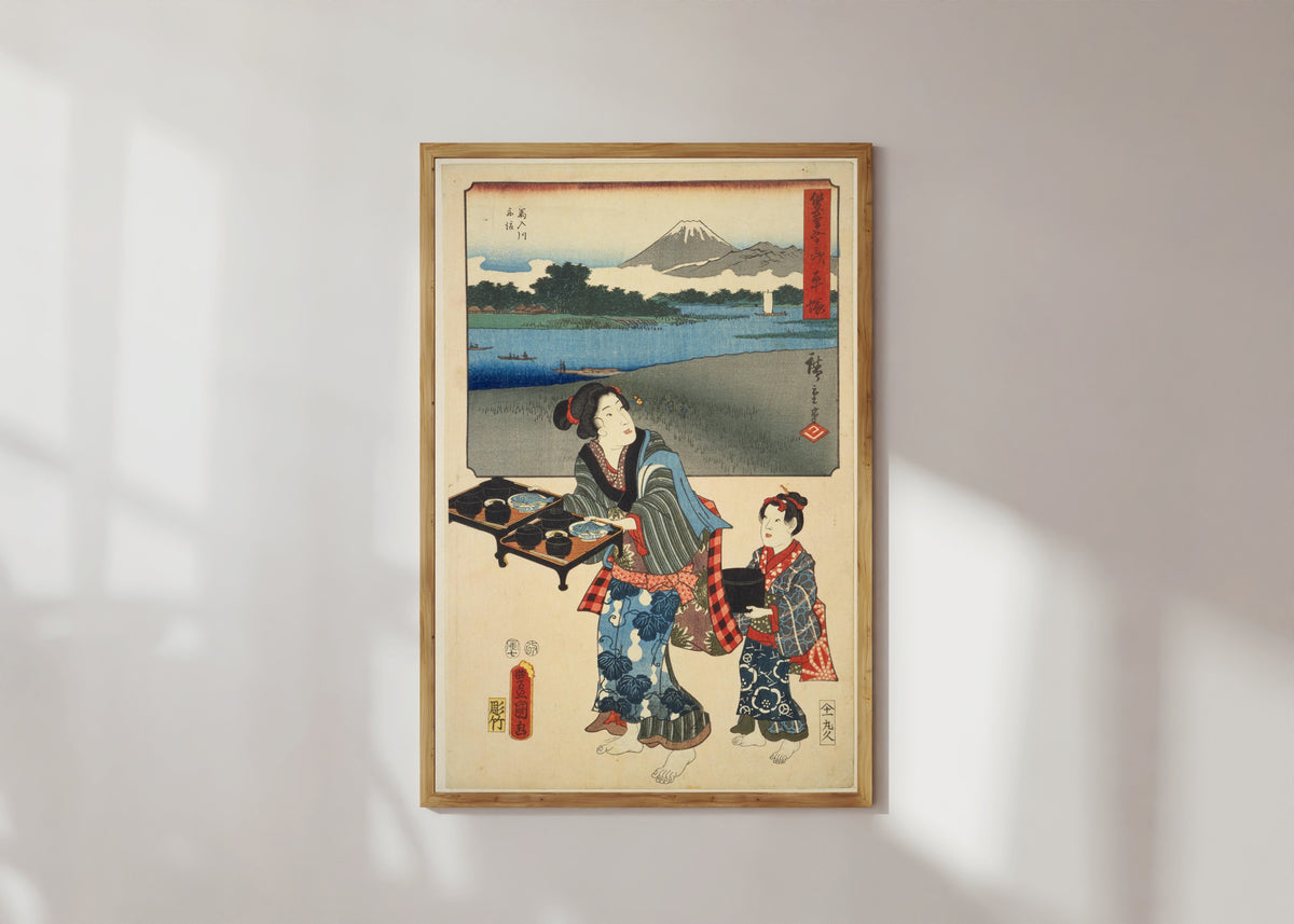 Framed art print of Fifty-three Stations by Two Brushes: Hiratsuka by Utagawa Hiroshige & Utagawa Kunisada, in a light wood frame on a sunlit white wall