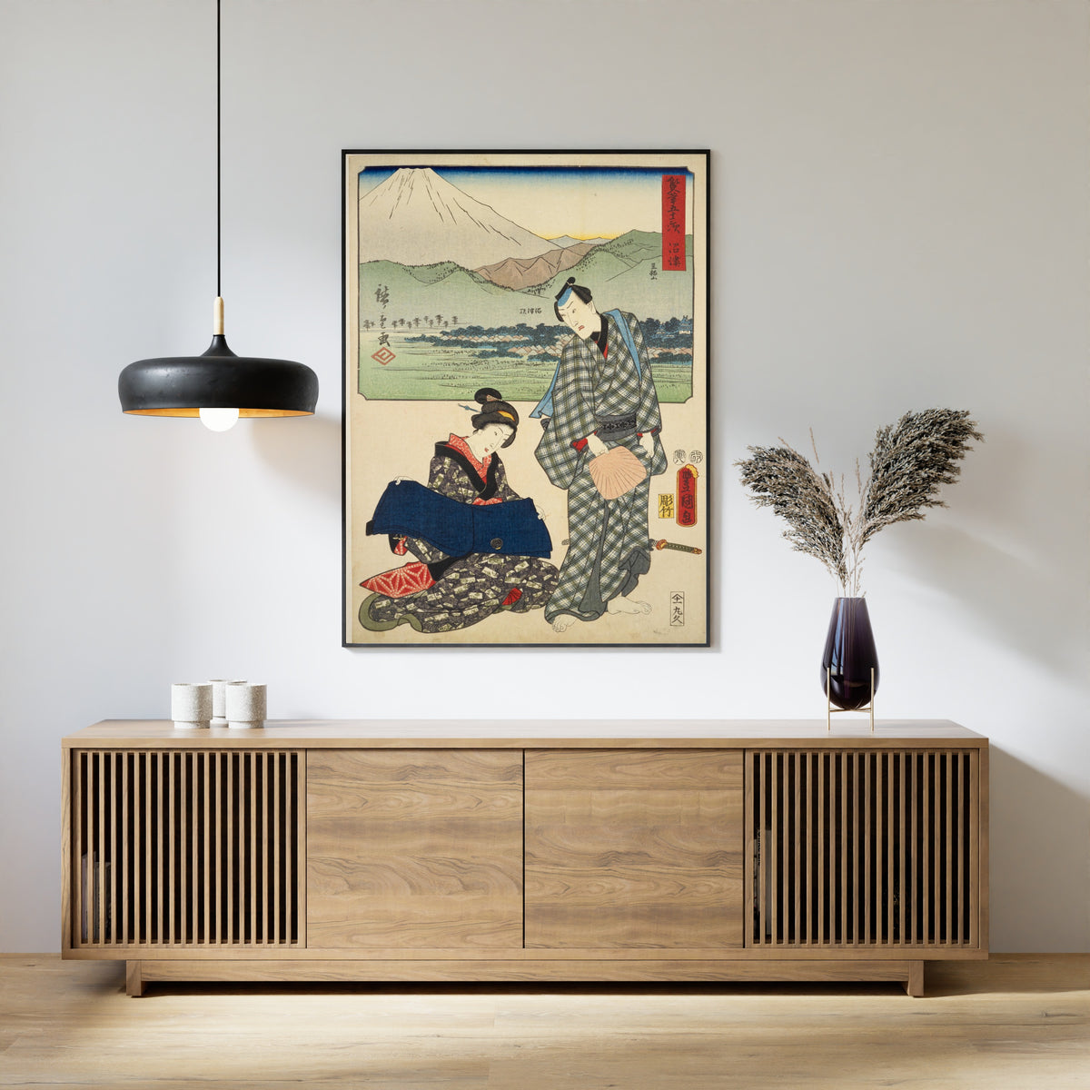 Fifty-three Stations by Two Brushes: Numazu by Utagawa Hiroshige & Utagawa Kunisada — framed above a slatted wood sideboard
