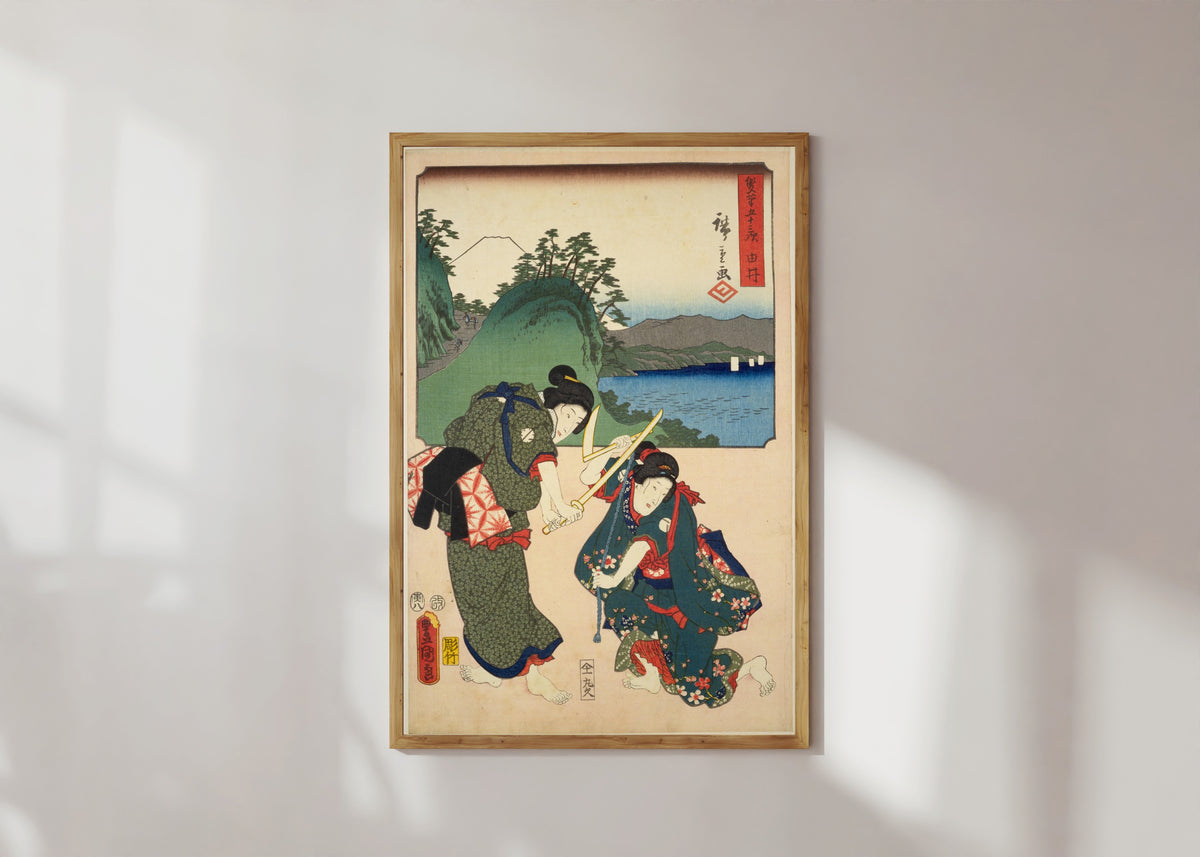 Framed art print of Fifty-three Stations by Two Brushes: Yui by Utagawa Hiroshige & Utagawa Kunisada, in a light wood frame on a sunlit white wall