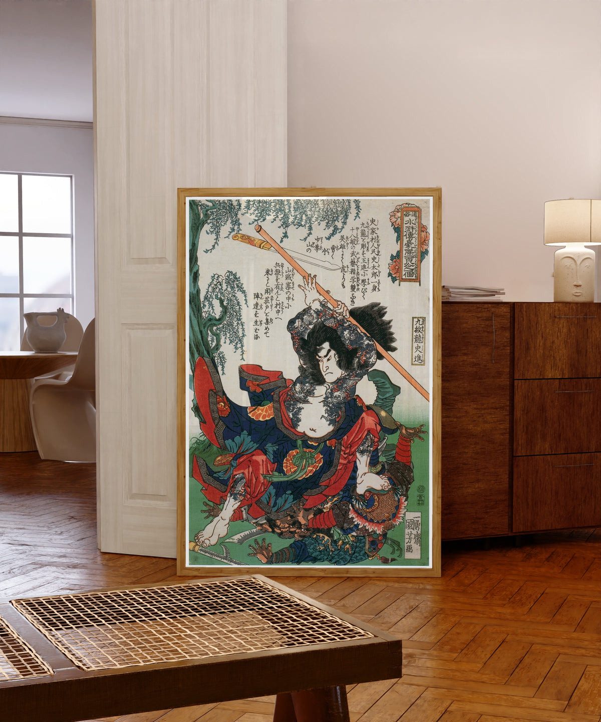 Framed art print of 108 Heroes of the Suikoden: Kumonryū Shishin… by Utagawa Kuniyoshi, in a light wood frame leaning in a warm room with a parquet floor