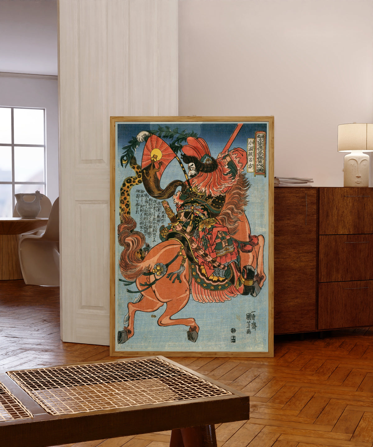 Framed art print of 108 Heroes of the Suikoden: Shōonkō Ryohō (Right… by Utagawa Kuniyoshi, in a light wood frame leaning in a warm room with a parquet floor
