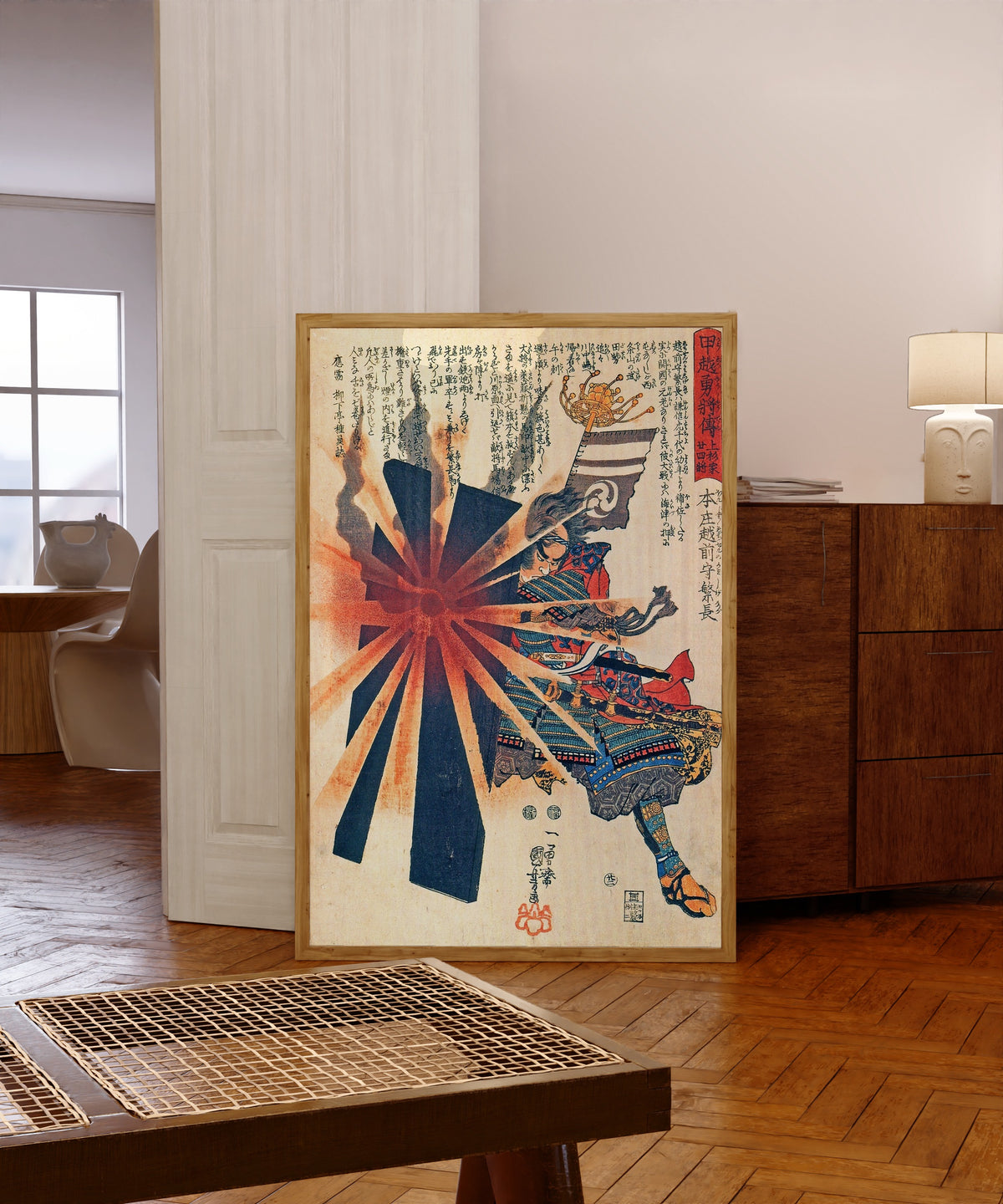 Framed art print of Honjō Shigenaga Parrying an Exploding Shell by Utagawa Kuniyoshi, in a light wood frame leaning in a warm room with a parquet floor