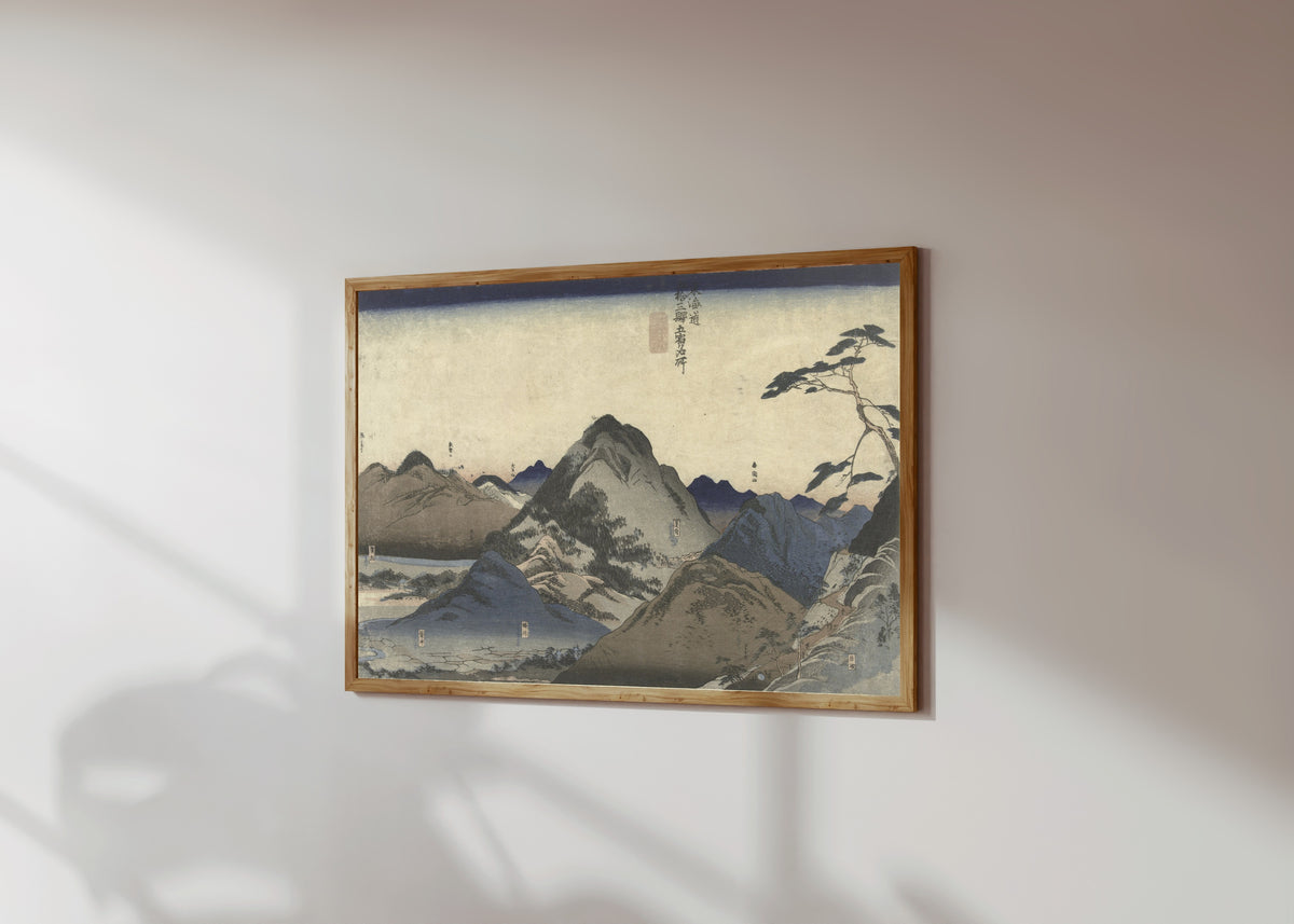 Framed art print of Nissaka to Hamamatsu (Tōkaidō) by Utagawa Kuniyoshi, in a light wood frame on a sunlit white wall, seen at a slight angle