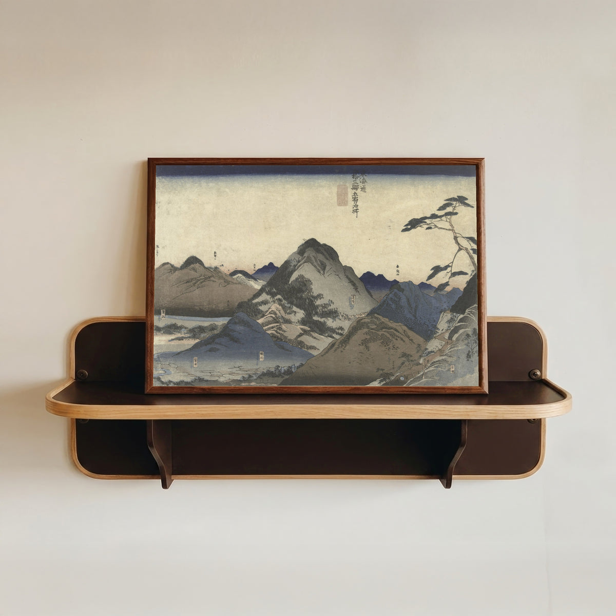 Framed art print of Nissaka to Hamamatsu (Tōkaidō) by Utagawa Kuniyoshi, in a dark wood frame resting on a wall shelf