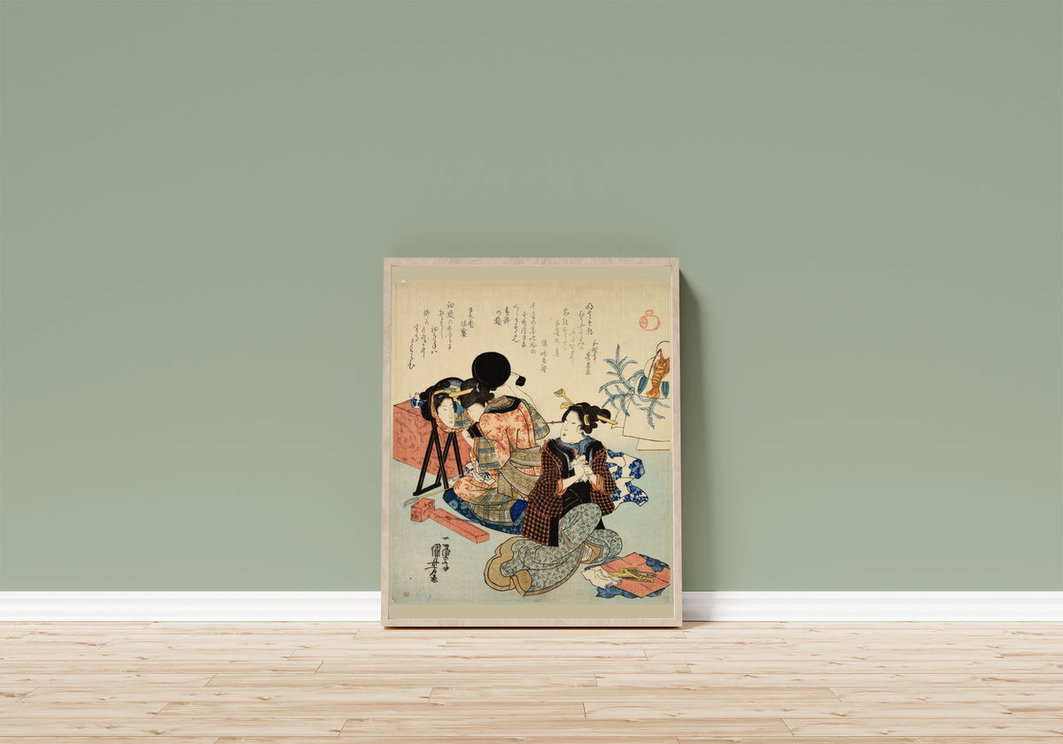 Framed art print of Two Women Back to Back, One with a Mirror by Utagawa Kuniyoshi, in a light wood frame leaning on a sage green wall above a wooden floor