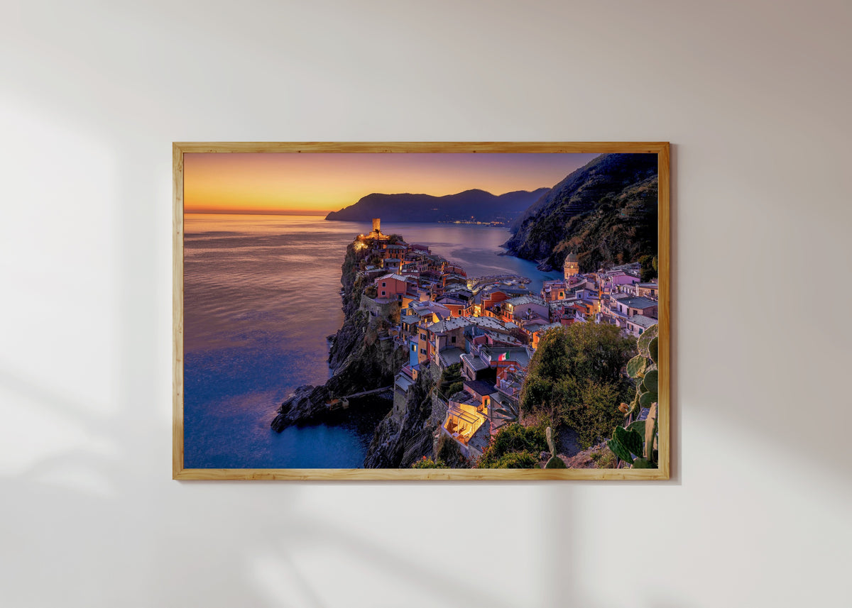 Framed art print of Vernazza Sunset by Pablo Meilán Campagnale, in a light wood frame on a sunlit white wall