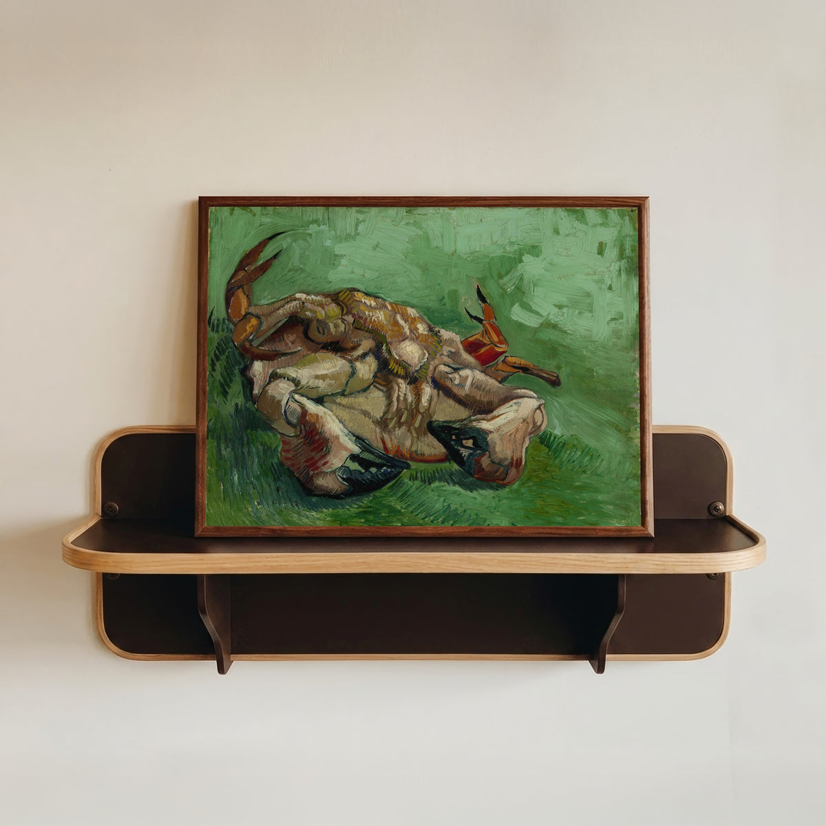 Framed art print of A Crab on its Back by Vincent van Gogh, in a dark wood frame resting on a wall shelf