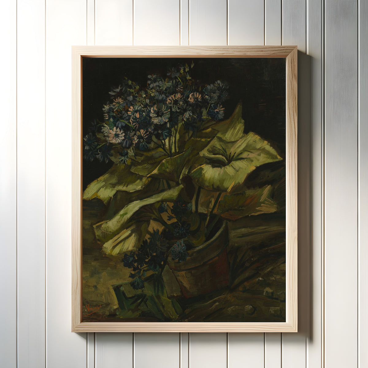 Framed art print of Cineraria by Vincent van Gogh, in a light wood frame on a white panelled wall
