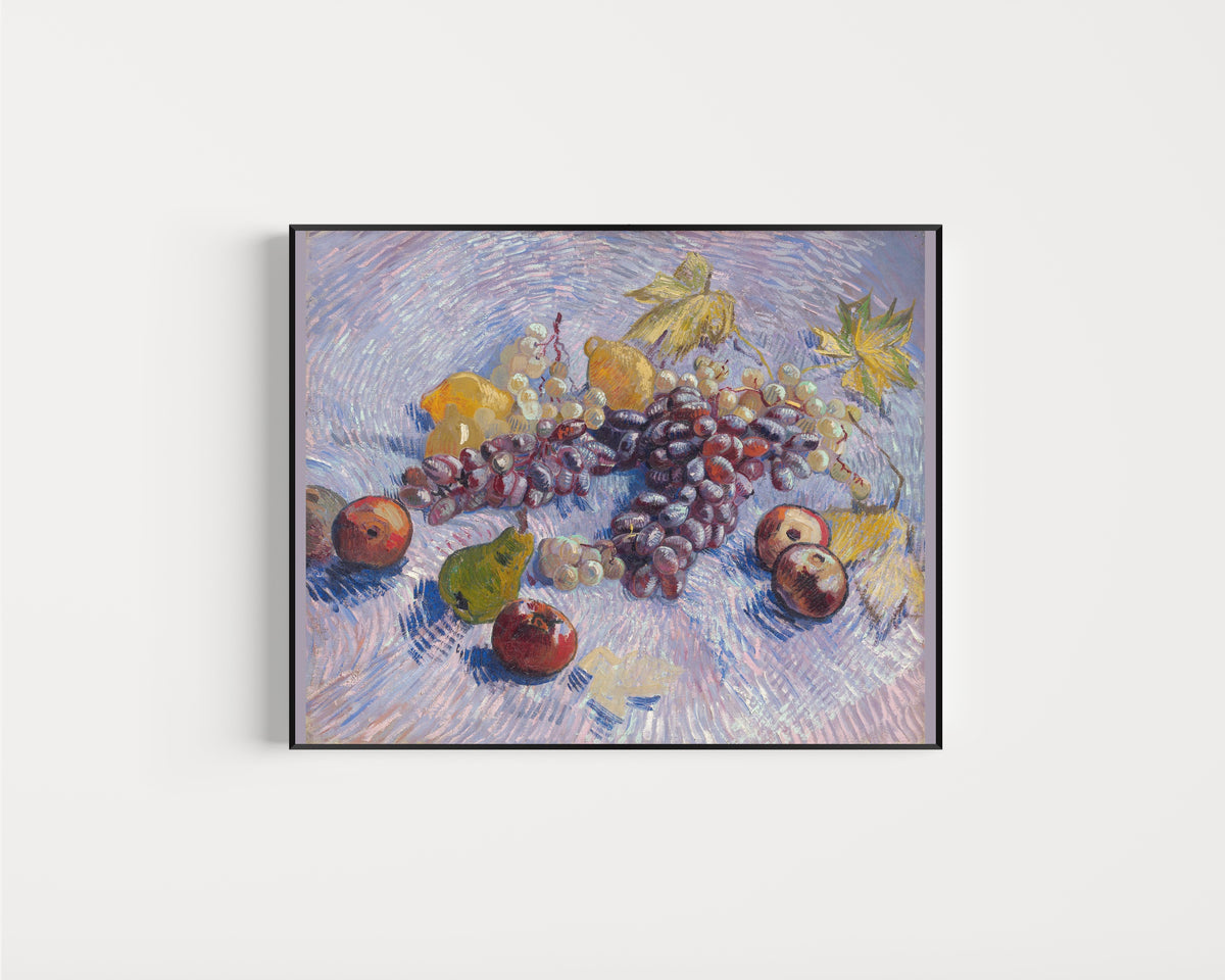 Framed art print of Grapes, Lemons, Pears and Apples by Vincent van Gogh, in a slim black frame on a plain white wall