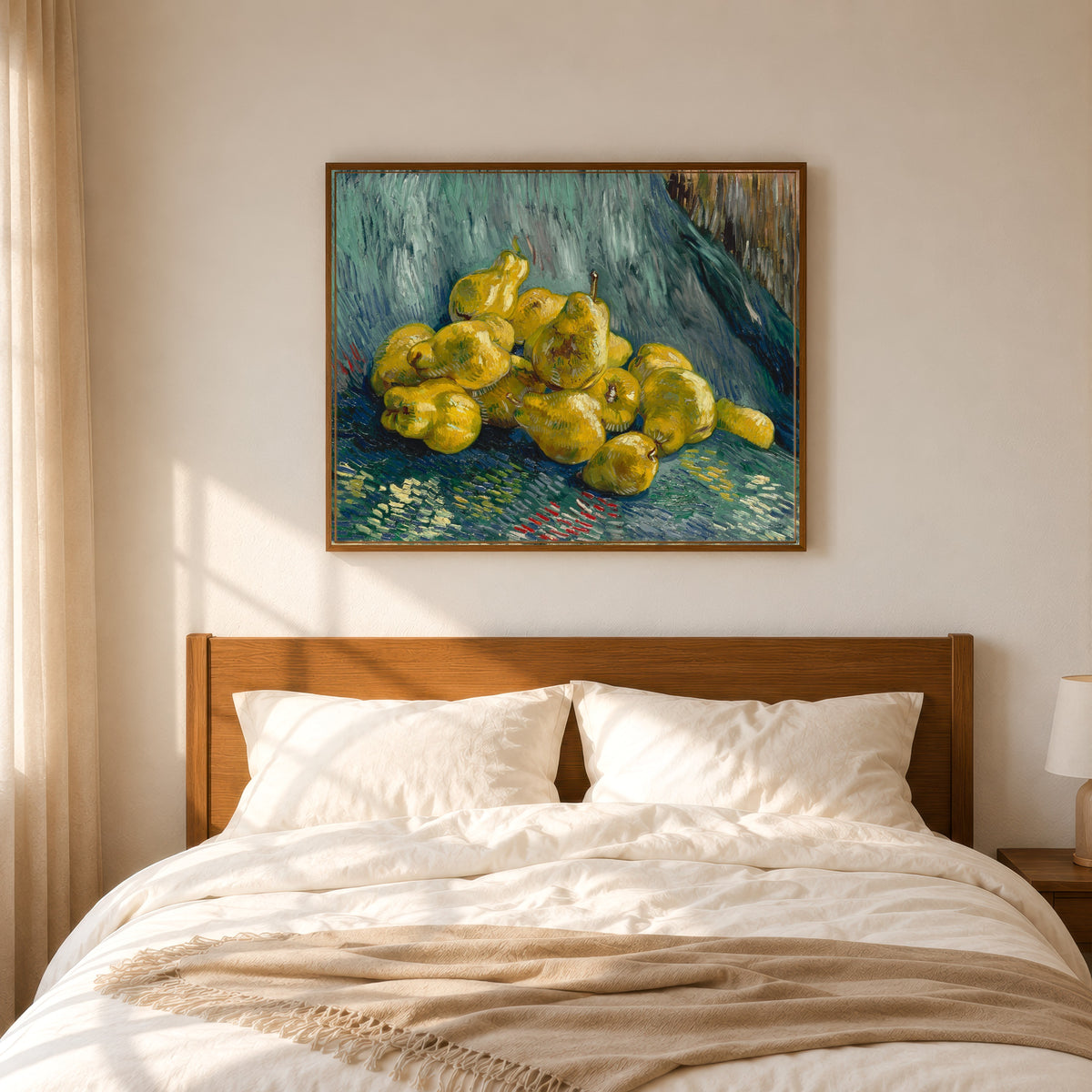 Framed art print of Still Life with Quinces by Vincent van Gogh, in a slim wood frame above a bed in a sunlit bedroom