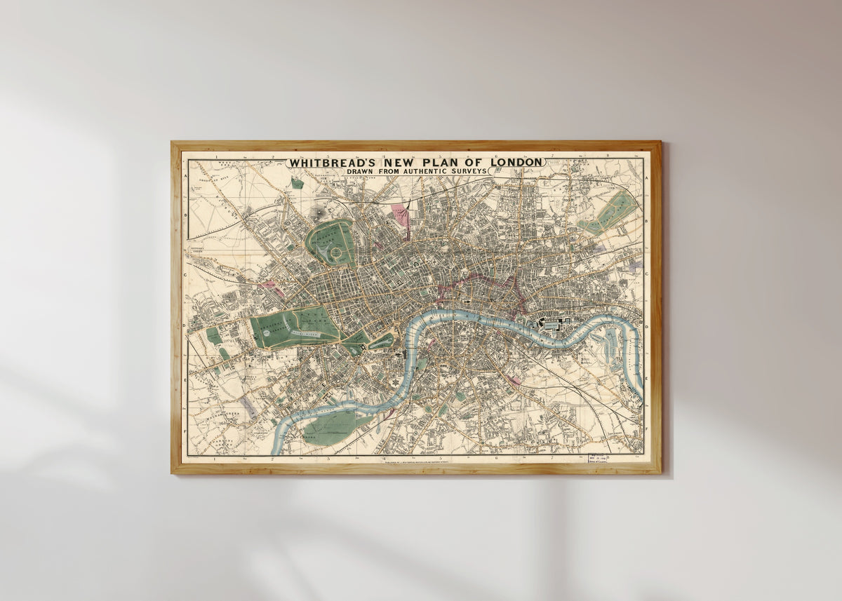 Framed art print of Whitbread's New Plan of London, in a light wood frame on a sunlit white wall