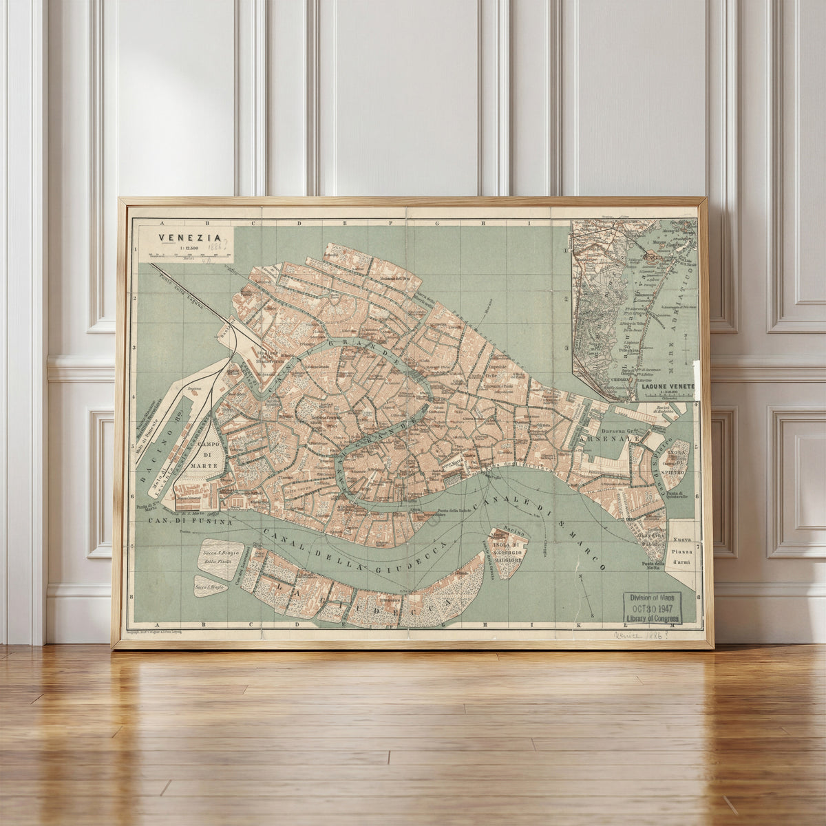 Framed art print of Venezia by Wagner & Debes, in a light wood frame leaning against a panelled white wall