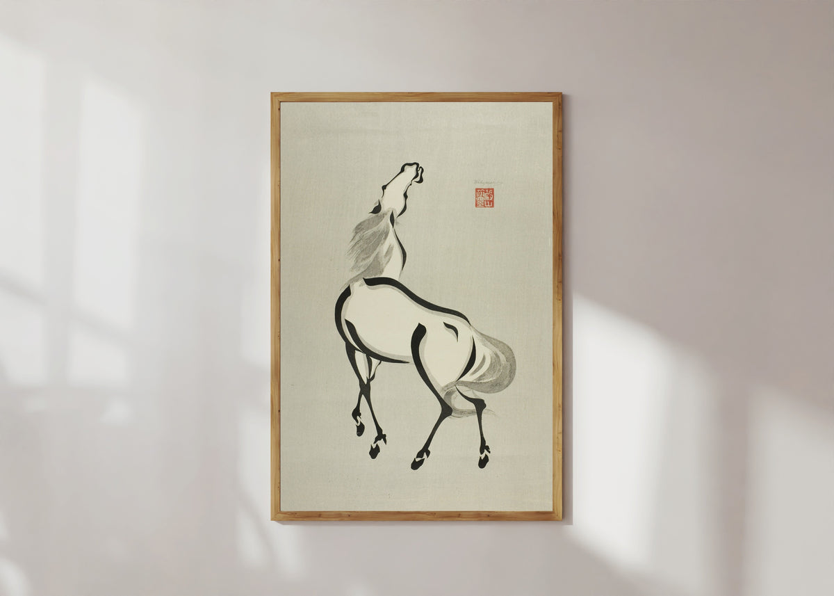 Framed art print of Horse with Raised Head by Wakyosai, in a light wood frame on a sunlit white wall