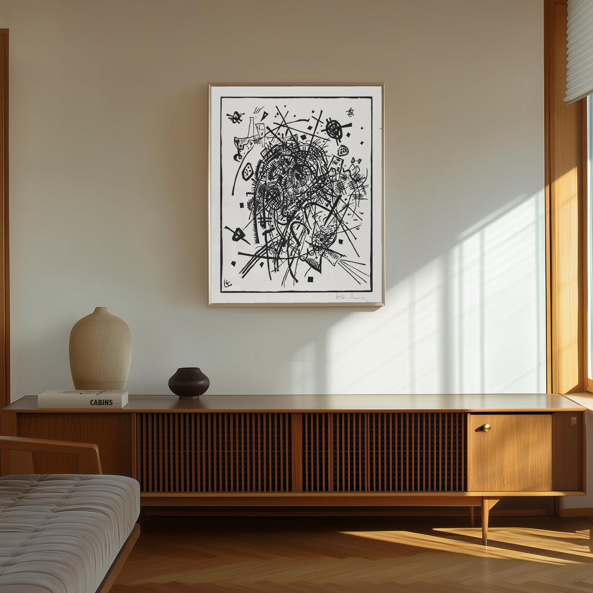 Framed art print of Small Worlds VIII by Wassily Kandinsky, in a thin light frame on a sunlit wall above a wooden sideboard