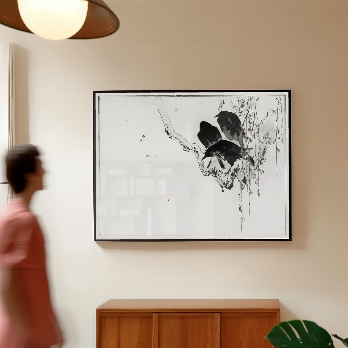 Framed art print of Japanese crows perched on a branch by Watanabe Seitei, in a slim black frame on a warm wall in a sunlit room