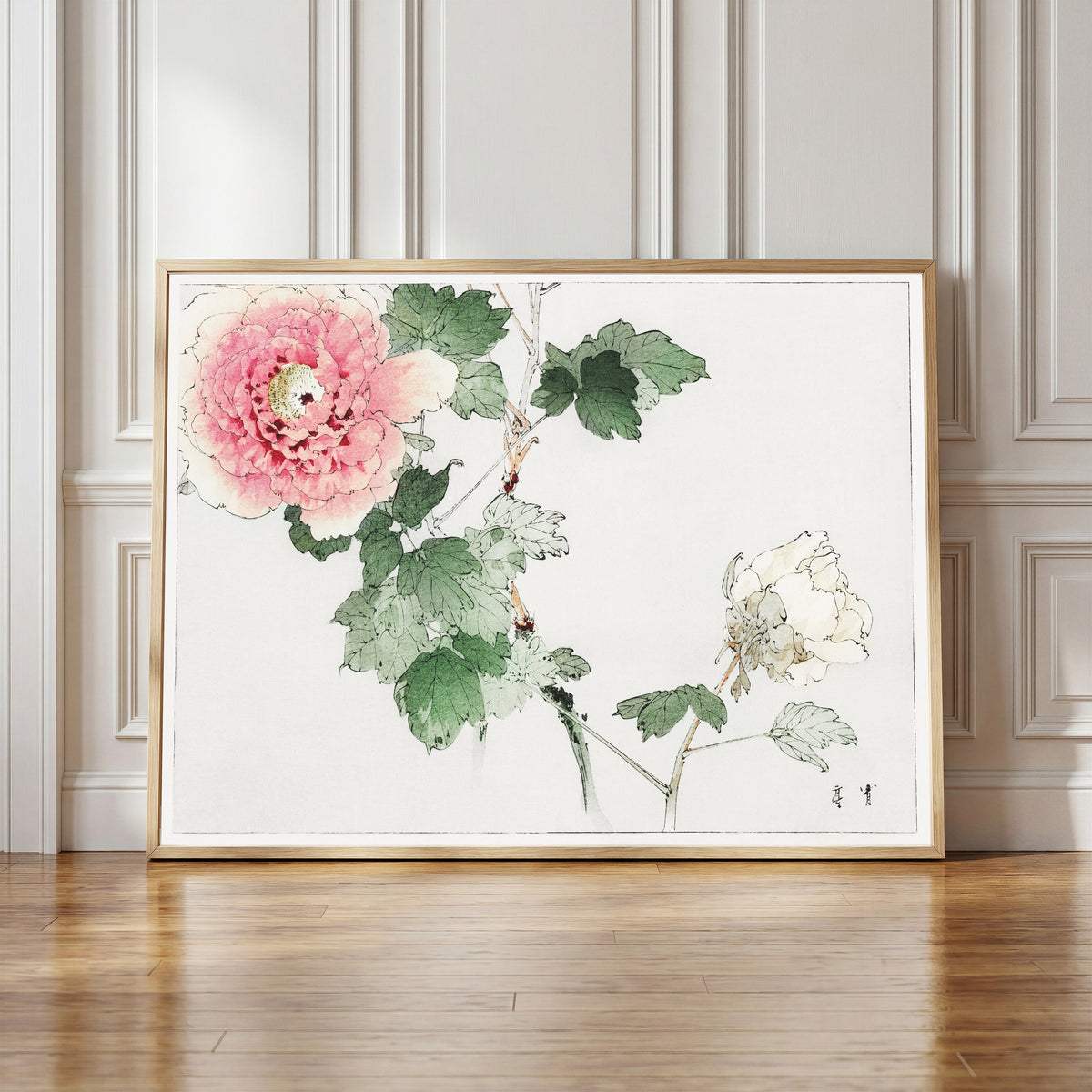 Framed art print of Tree Peony by Watanabe Seitei, in a light wood frame leaning against a panelled white wall