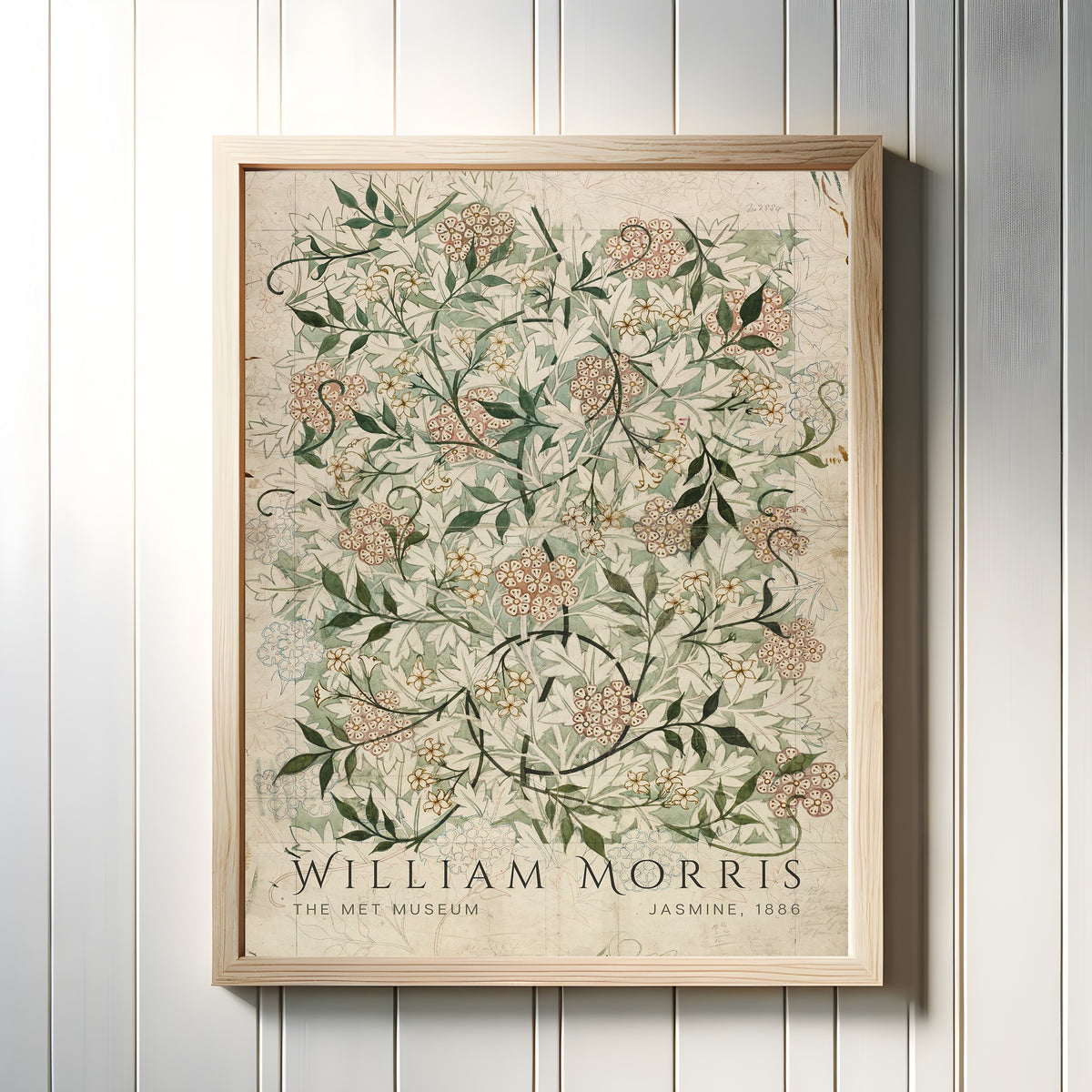 Framed art print of Jasmine by William Morris, in a light wood frame on a white panelled wall