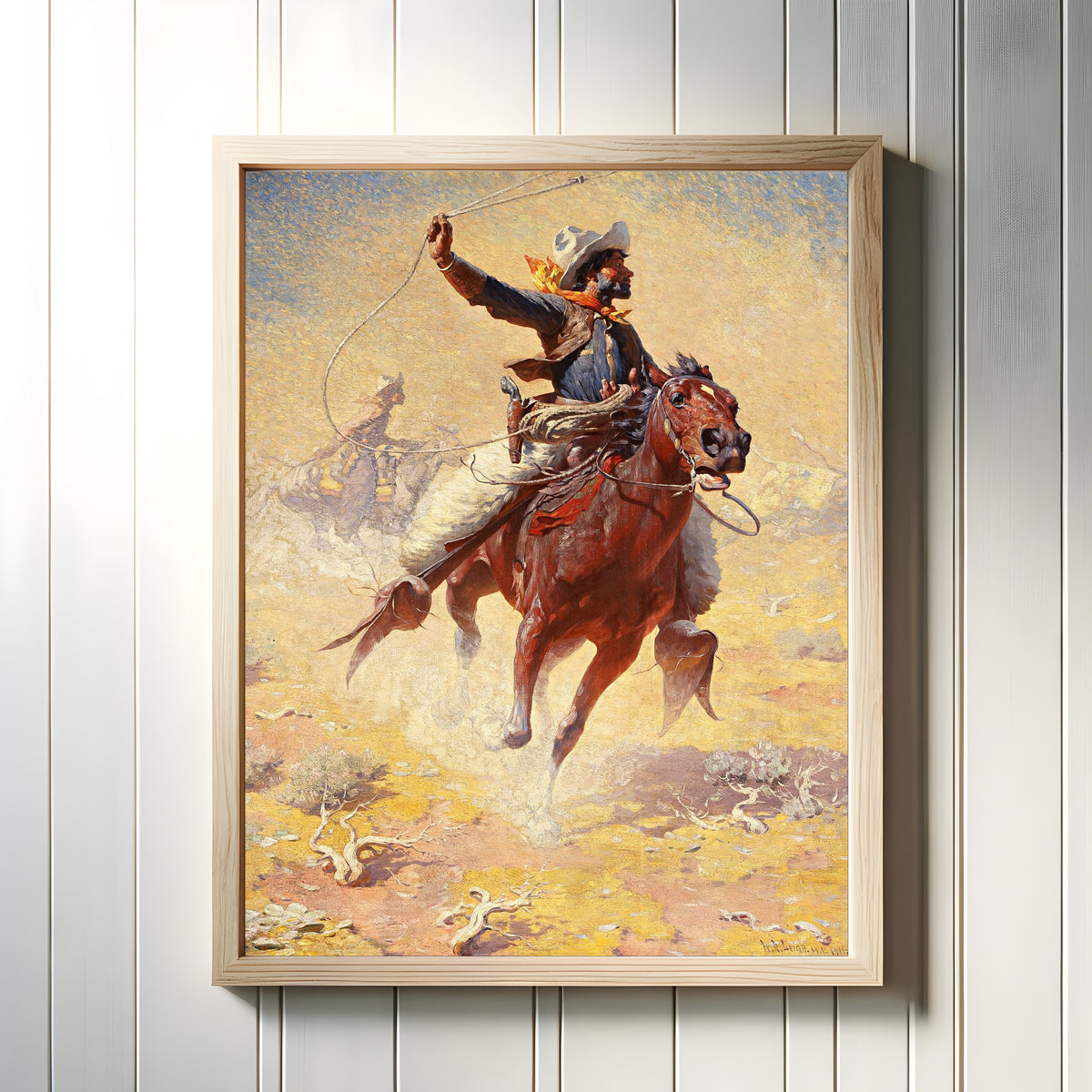 Framed art print of The Roping by William Robinson Leigh, in a light wood frame on a white panelled wall
