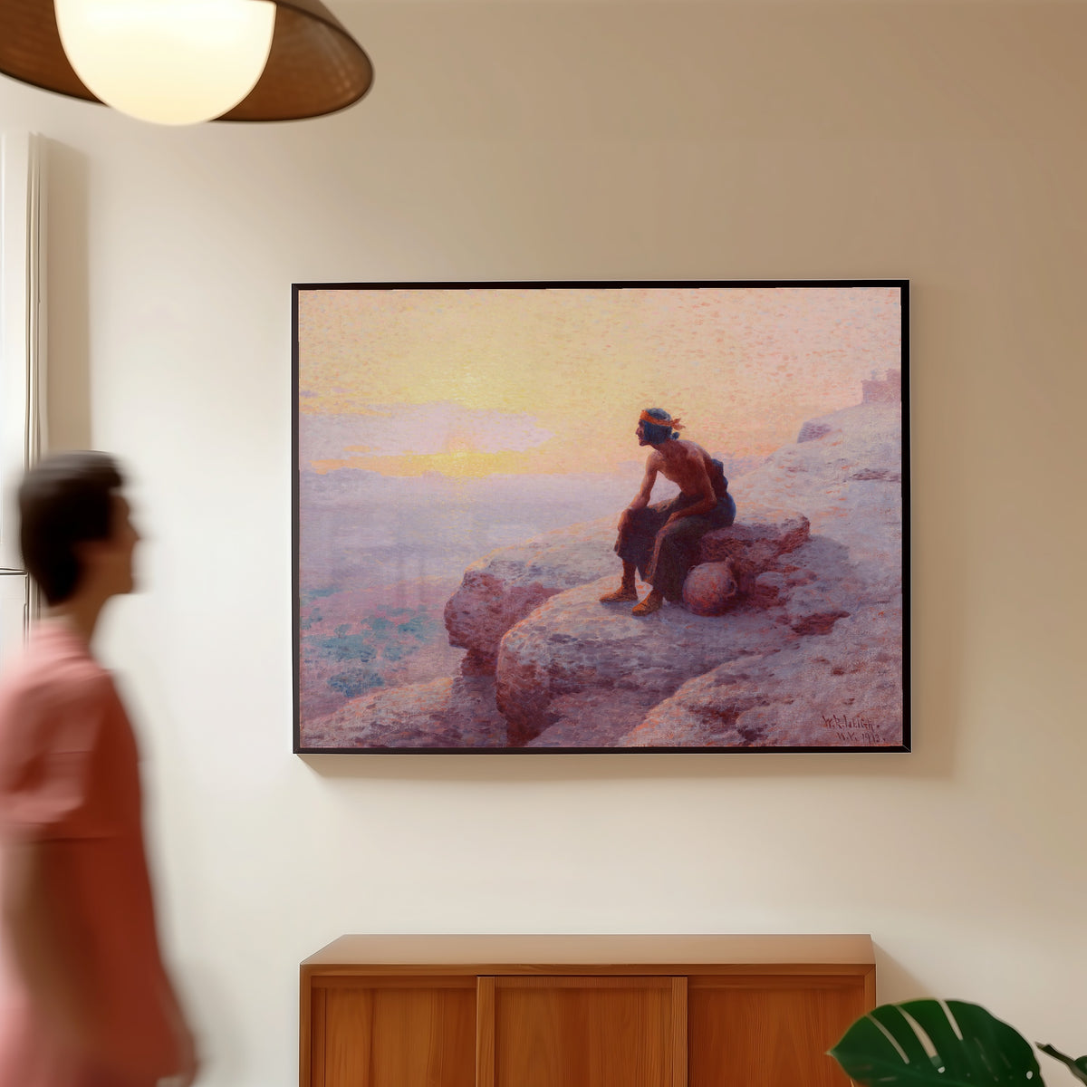 Framed art print of The Water Carrier by William Robinson Leigh, in a slim black frame on a warm wall in a sunlit room