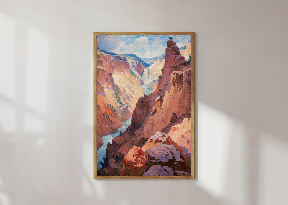 Framed art print of View of the Grand Canyon of the Yellowstone by William Robinson Leigh, in a light wood frame on a sunlit white wall