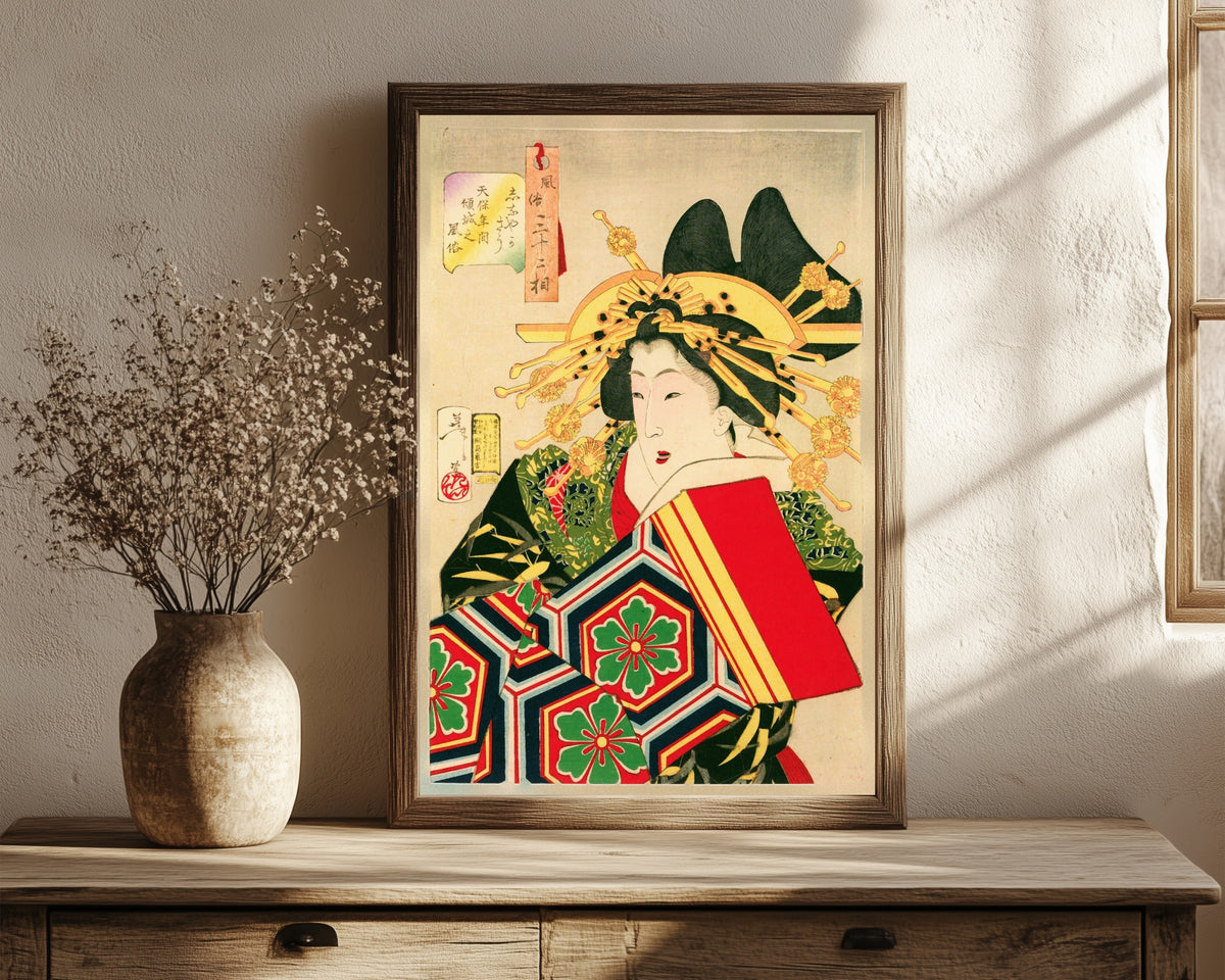 Framed art print of The Geisha by Tsukioka Yoshitoshi, in a dark wood frame leaning on a rustic console beside dried flowers
