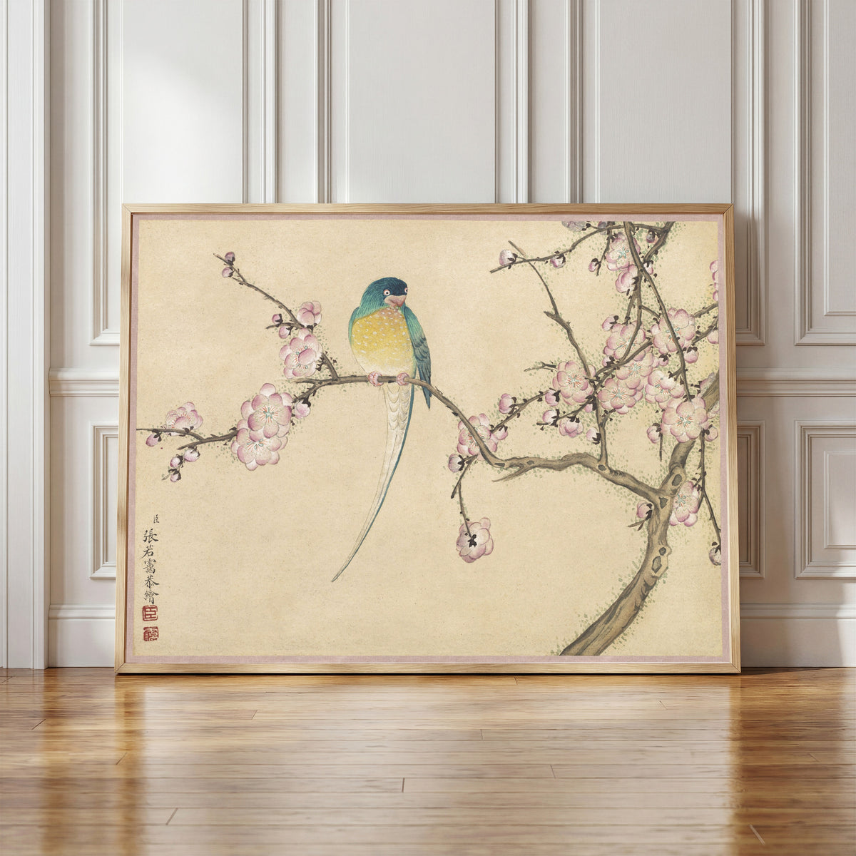 Framed art print of Desk Album: Flower and Bird Paintings (Bird with Plum Blossoms) by Zhang Ruoai, in a light wood frame leaning against a panelled white wall