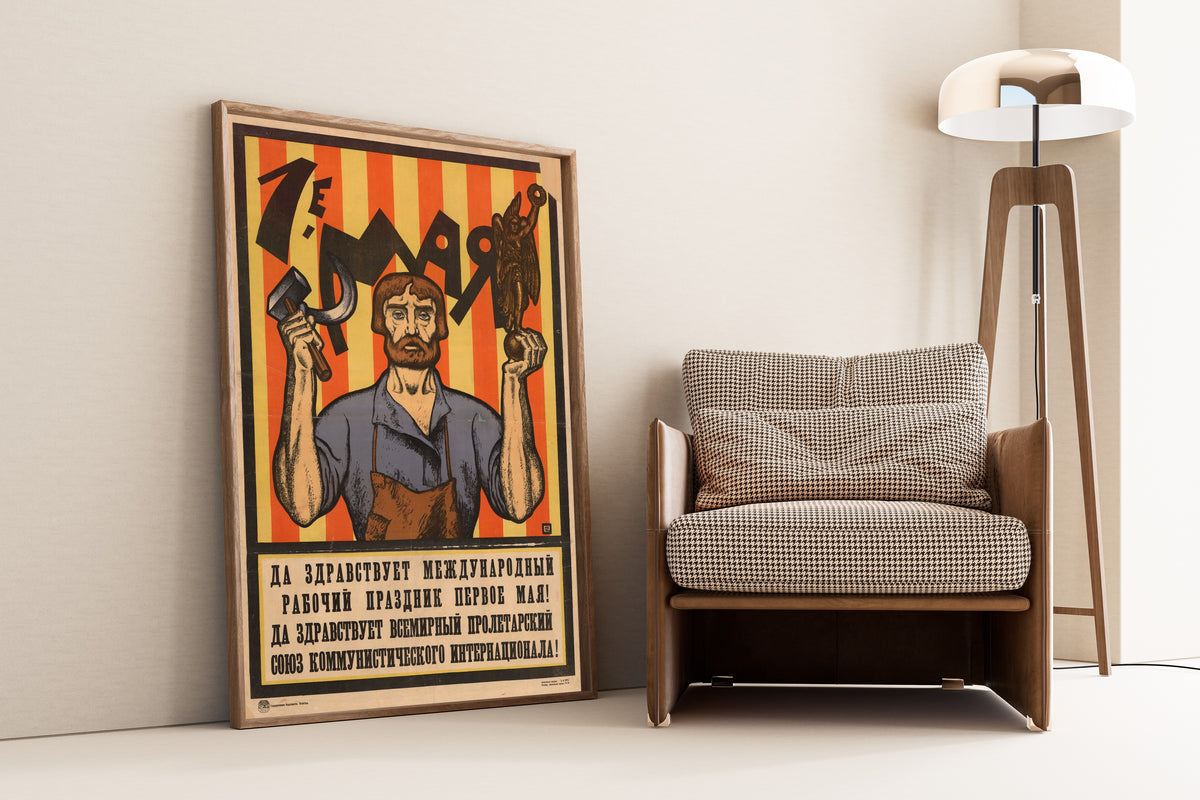Framed art print of 1st of May. Long Live the International Workers' Holiday, the… by Sergey Ivanov, leaning against a wall beside an armchair and a floor lamp