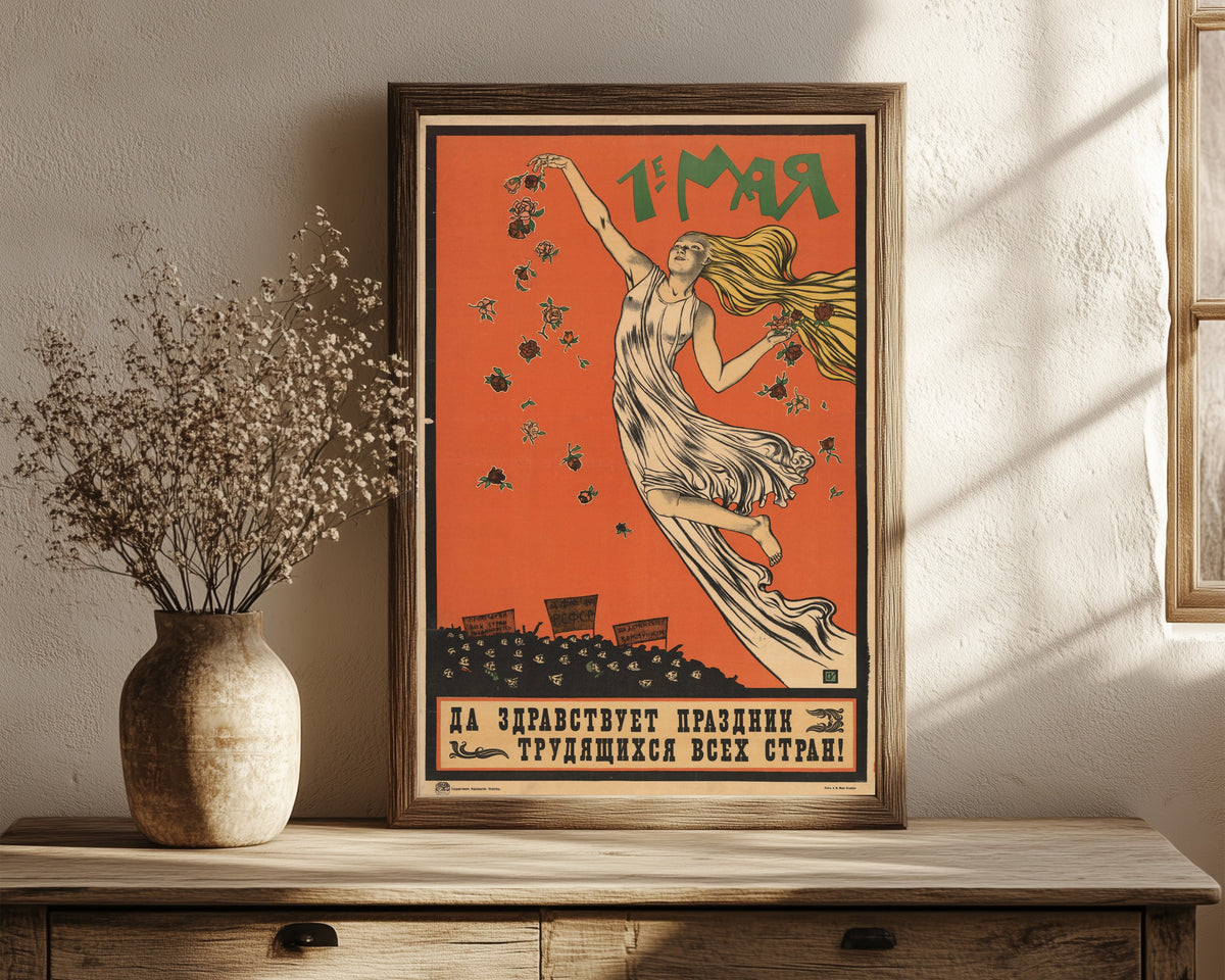 Framed art print of 1st of May. Long live the holiday of the working… by Sergey Ivanov, in a dark wood frame leaning on a rustic console beside dried flowers