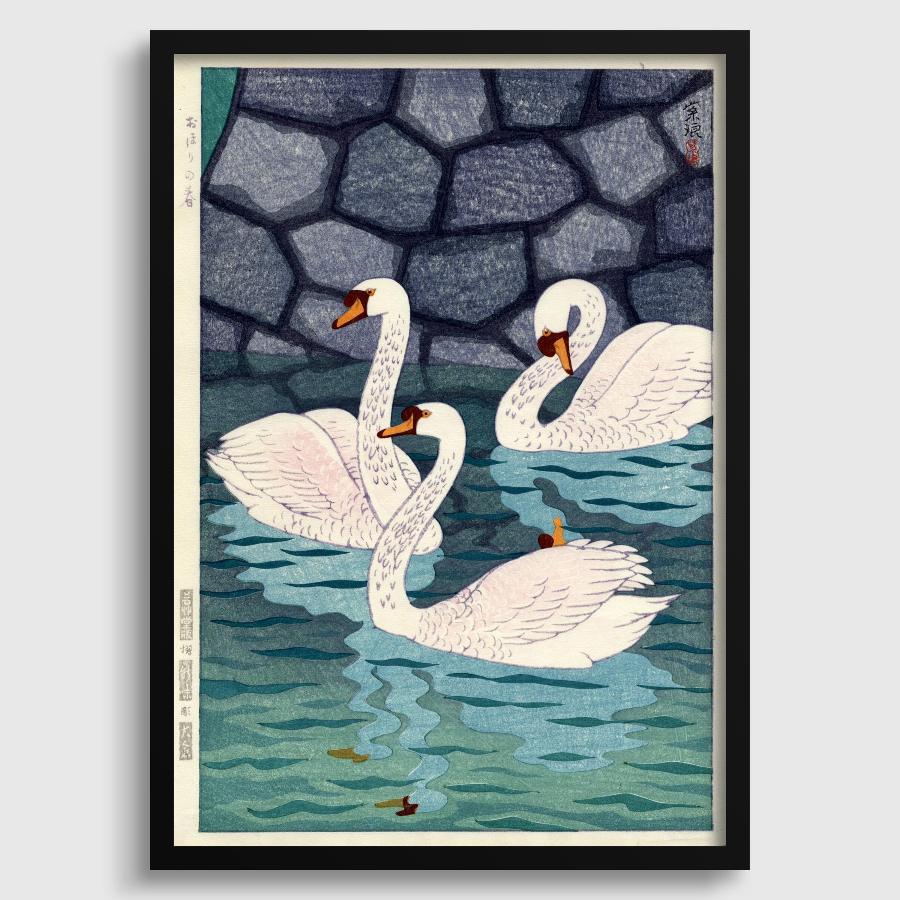 A framed print depicting three swans swimming in a body of water, with a stone wall in the background.