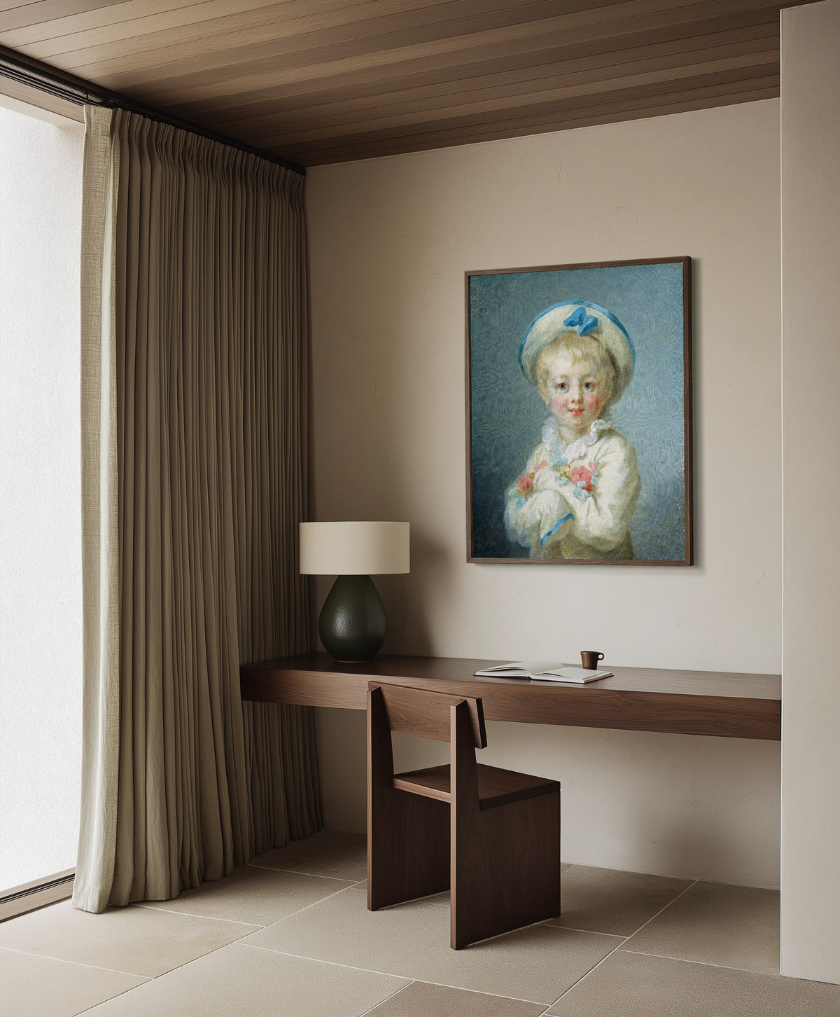 Framed art print of A Boy as Pierrot by Jean-Honoré Fragonard, in a dark wood frame on a plaster wall above a walnut desk