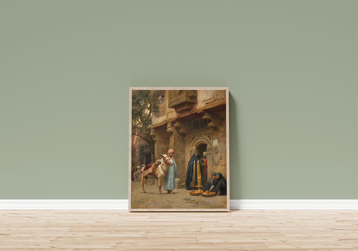 Framed art print of A Cairo Street by Frederick Arthur Bridgman, in a light wood frame leaning on a sage green wall above a wooden floor