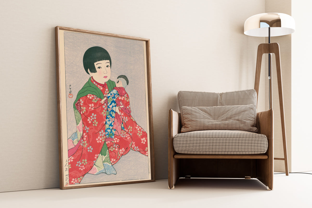 Framed art print of A Doll by Kawase Hasui, leaning against a wall beside an armchair and a floor lamp