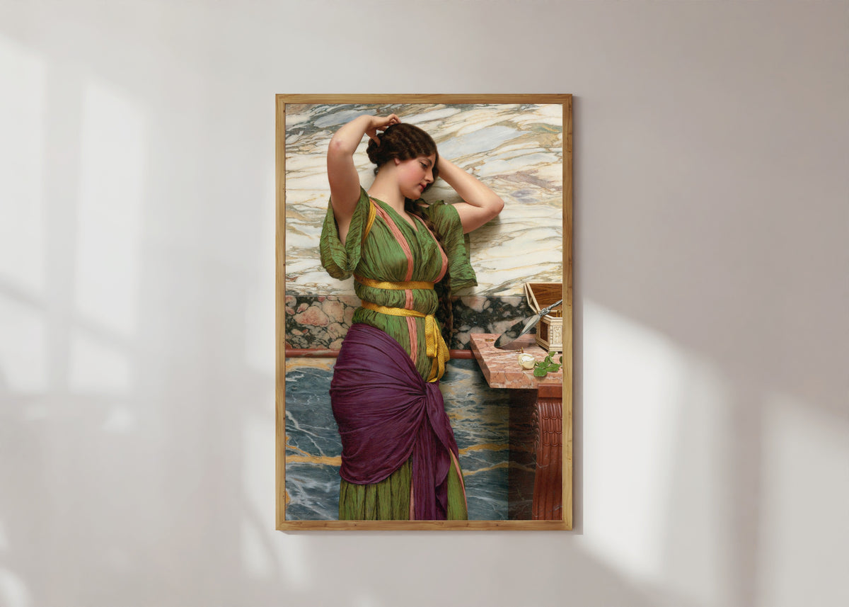Framed art print of A Fair Reflection by John William Godward, in a light wood frame on a sunlit white wall