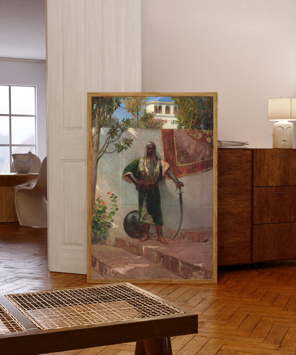 Framed art print of A Janissary by Jean-Joseph Benjamin-Constant, in a light wood frame leaning in a warm room with a parquet floor