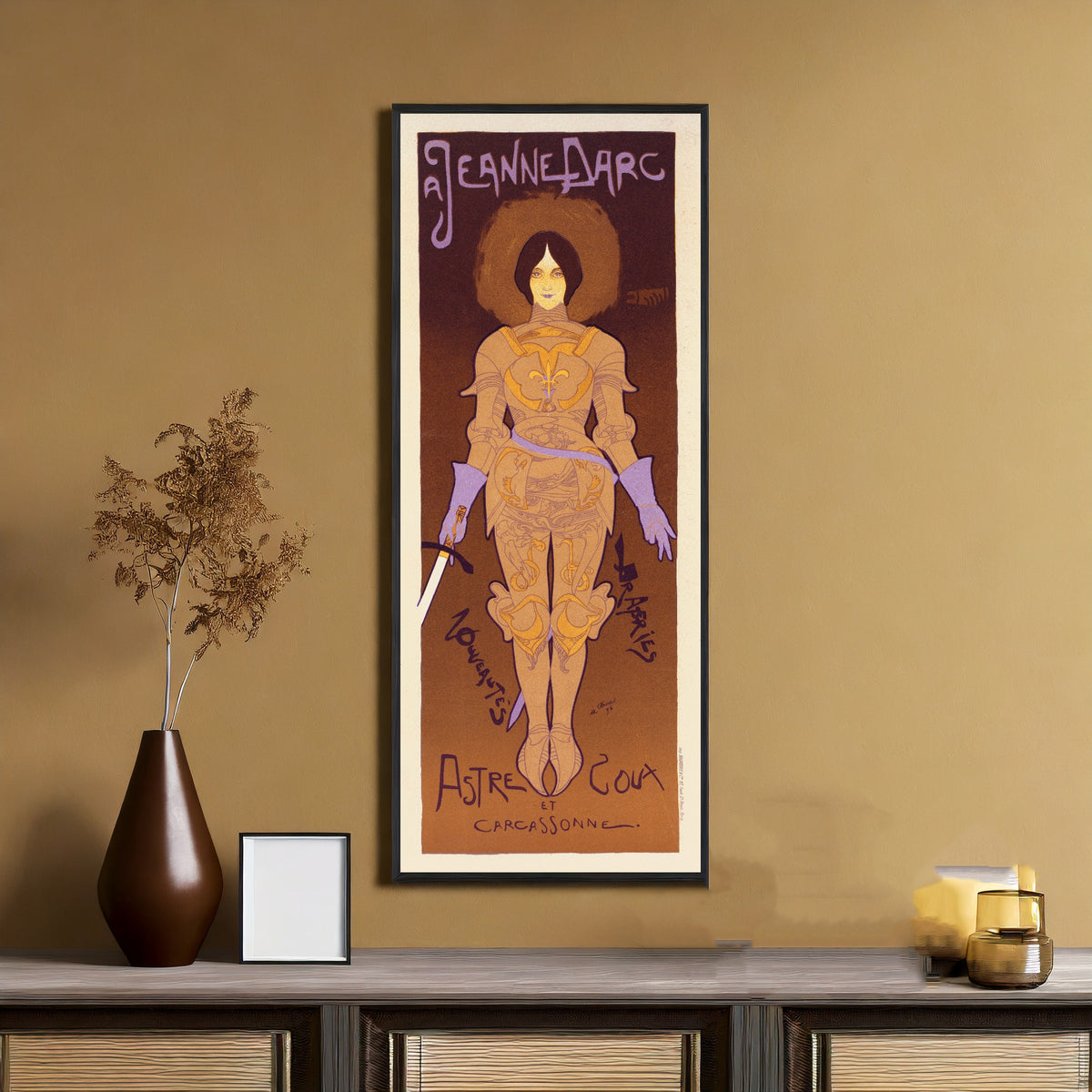 Framed art print of A Jeanne d'Arc by Georges de Feure, on an ochre wall above a console table