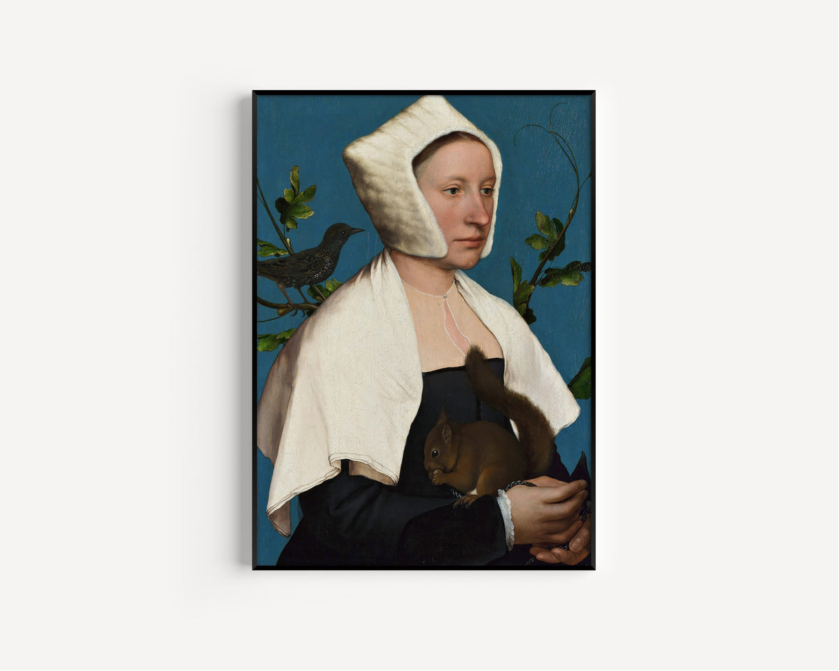Framed art print of A Lady with a Squirrel and a Starling by Hans Holbein the Younger, in a slim black frame on a plain white wall