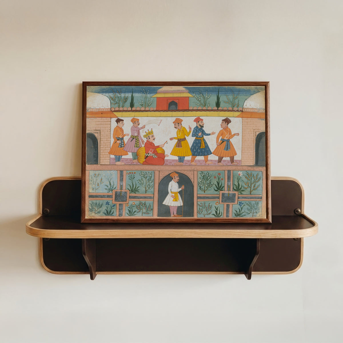 Framed art print of A Messenger Is Dispatched by Bilaspur school, in a dark wood frame resting on a wall shelf