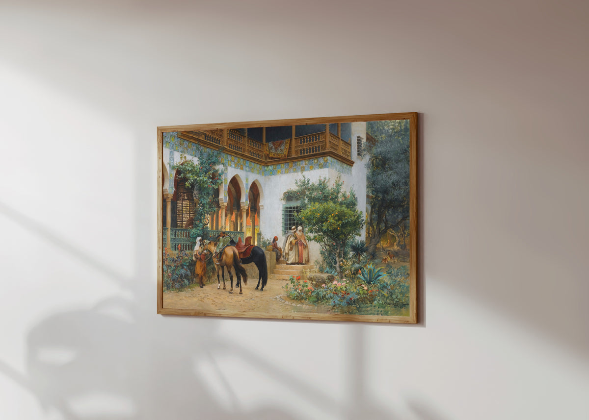 Framed art print of A North African Courtyard by Frederick Arthur Bridgman, in a light wood frame on a sunlit white wall, seen at a slight angle