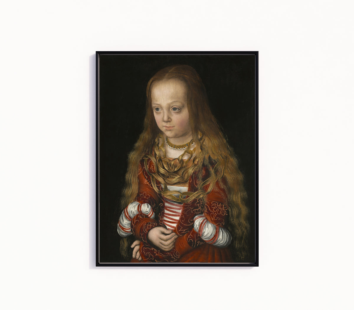 Framed art print of A Princess of Saxony by Lucas Cranach the Elder, in a slim black frame on a plain white wall