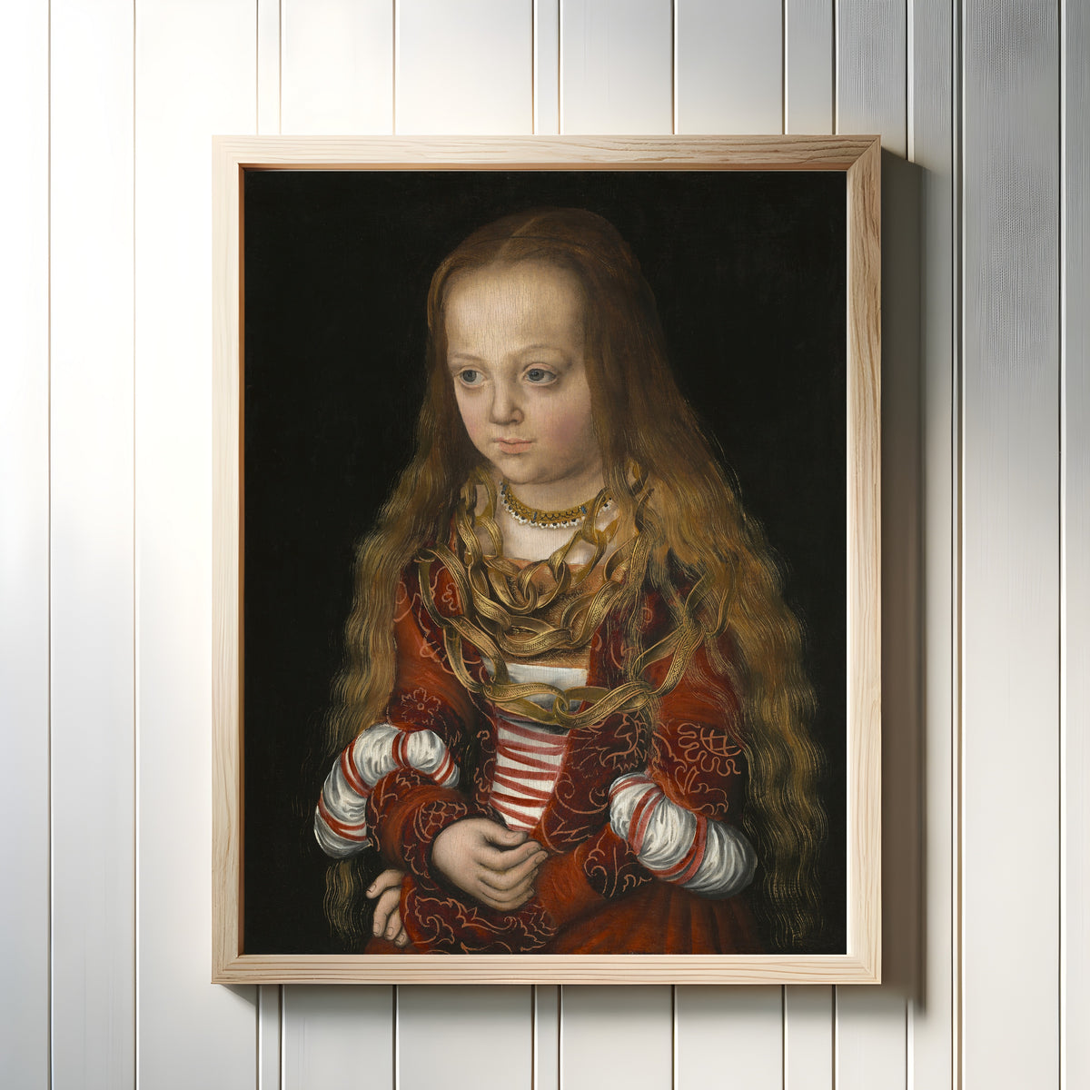Framed art print of A Princess of Saxony by Lucas Cranach the Elder, in a light wood frame on a white panelled wall