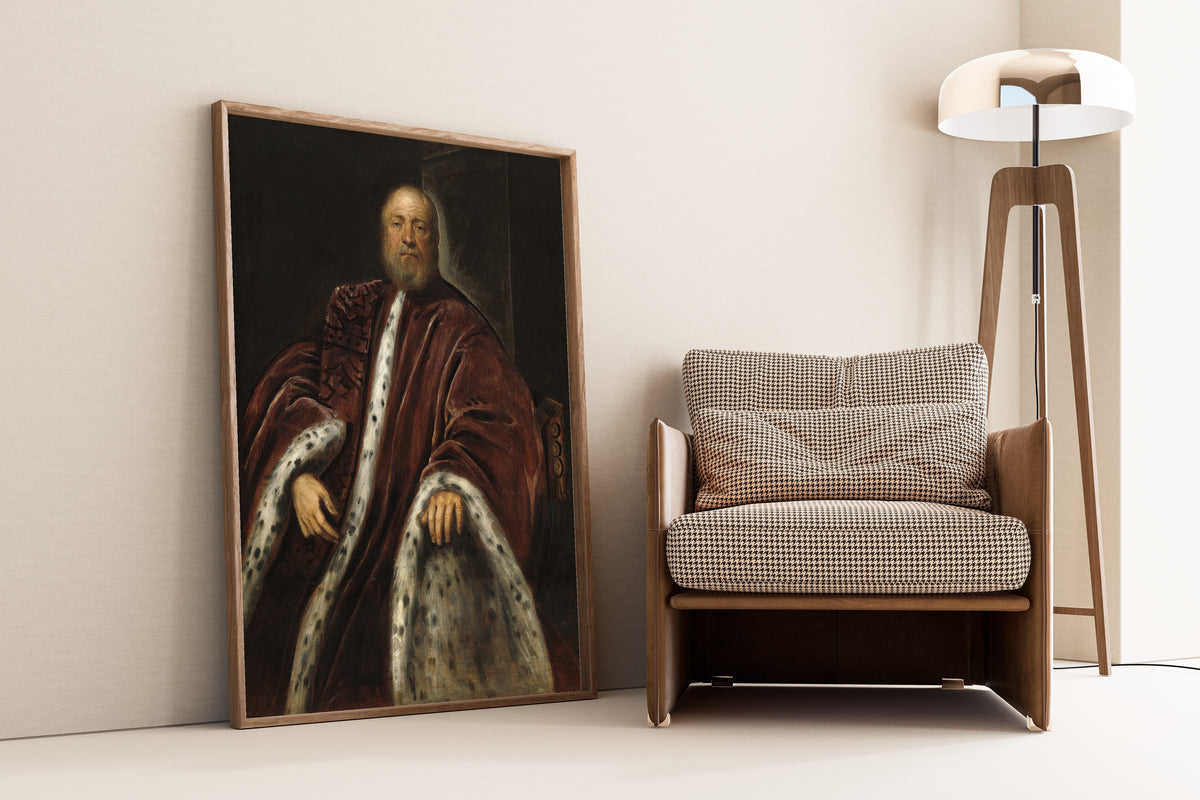 Framed art print of A Procurator of Saint Mark’s by Tintoretto, leaning against a wall beside an armchair and a floor lamp