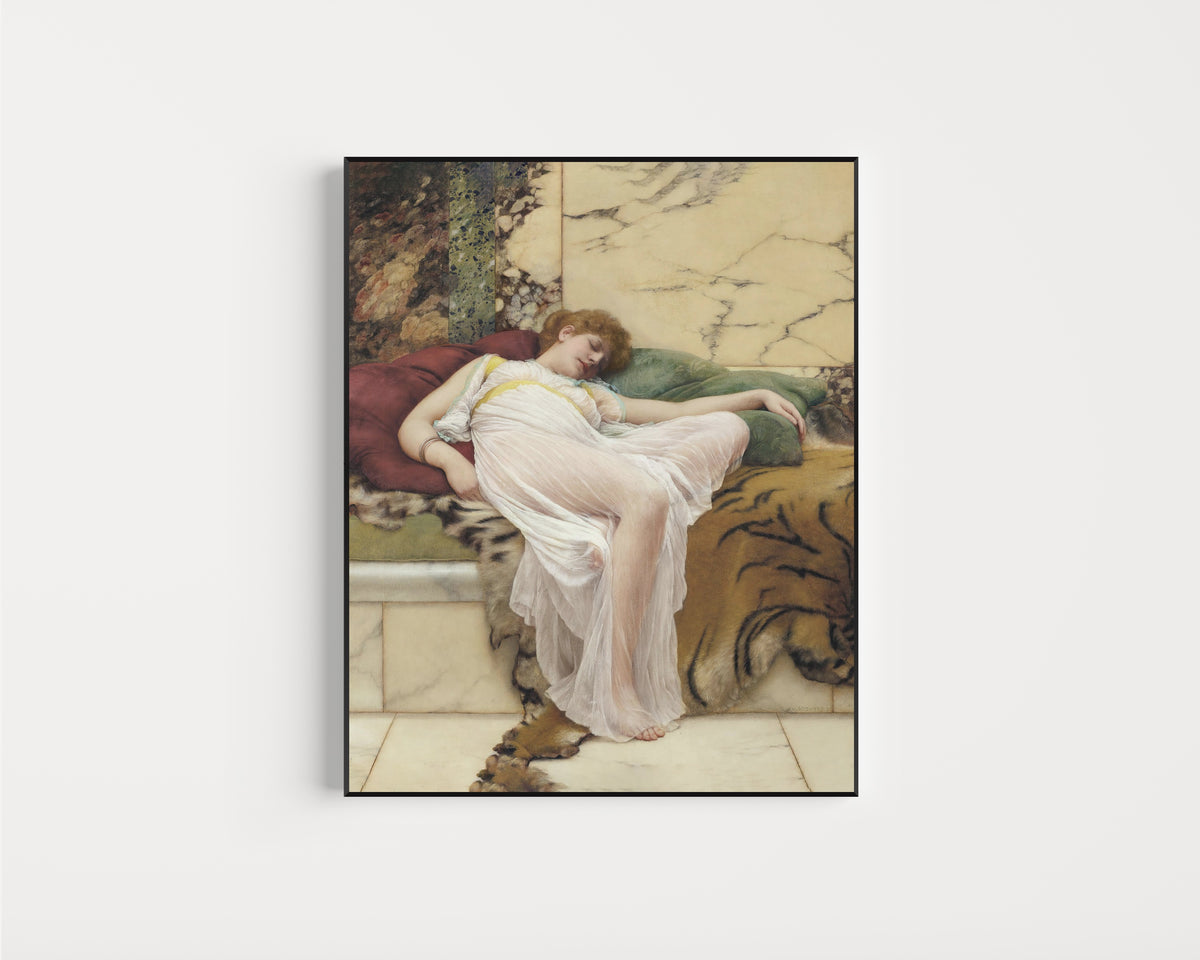 Framed art print of A Siesta by John William Godward, in a slim black frame on a plain white wall