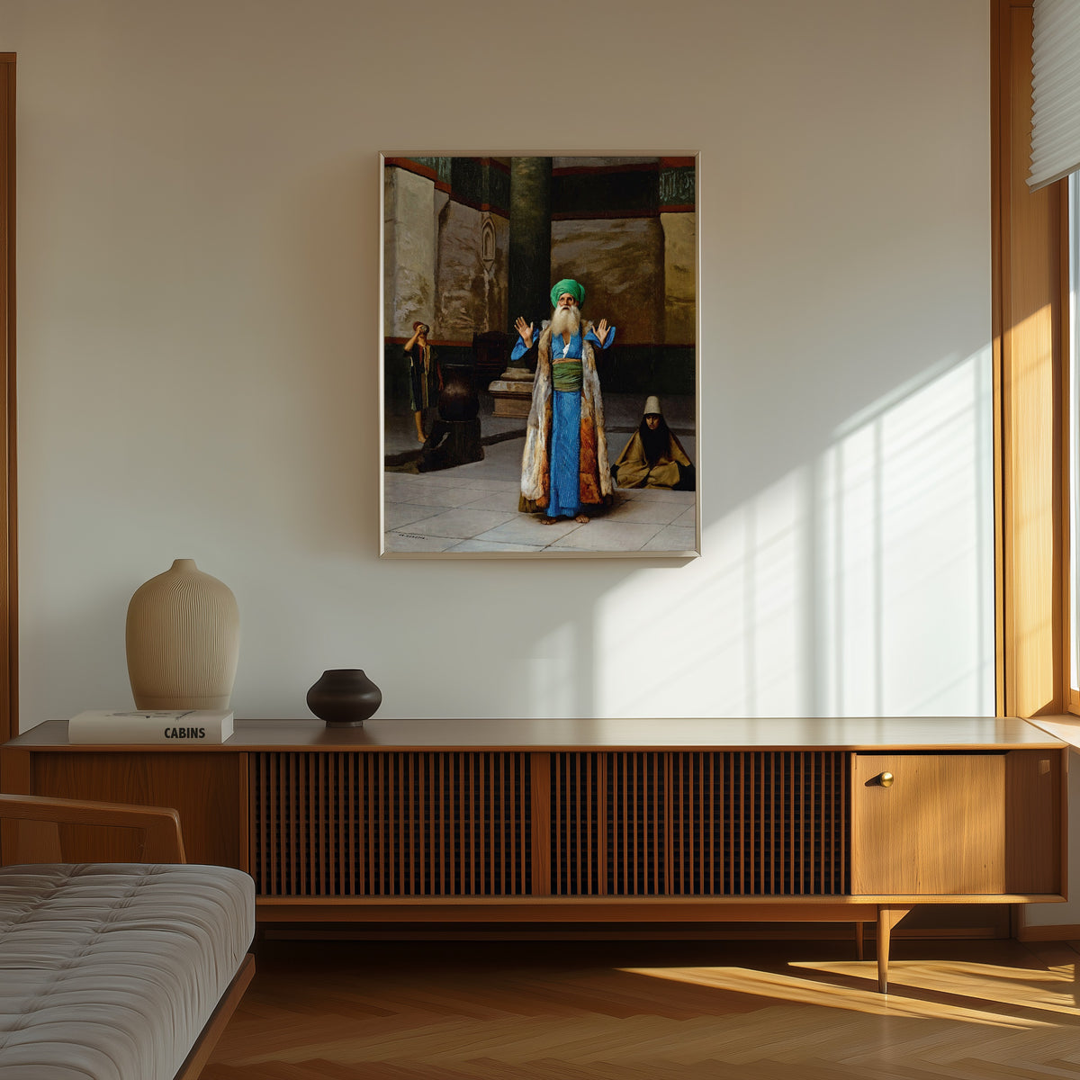 Framed art print of A Sultan at Prayer by Jean-Léon Gérôme, in a thin light frame on a sunlit wall above a wooden sideboard