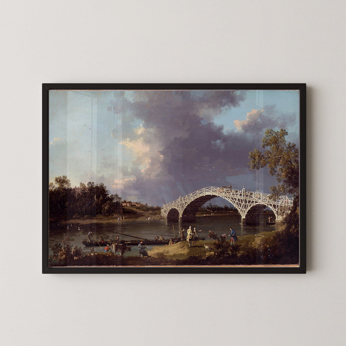 Framed art print of A View of Walton Bridge by Canaletto, in a black frame on a pale wall