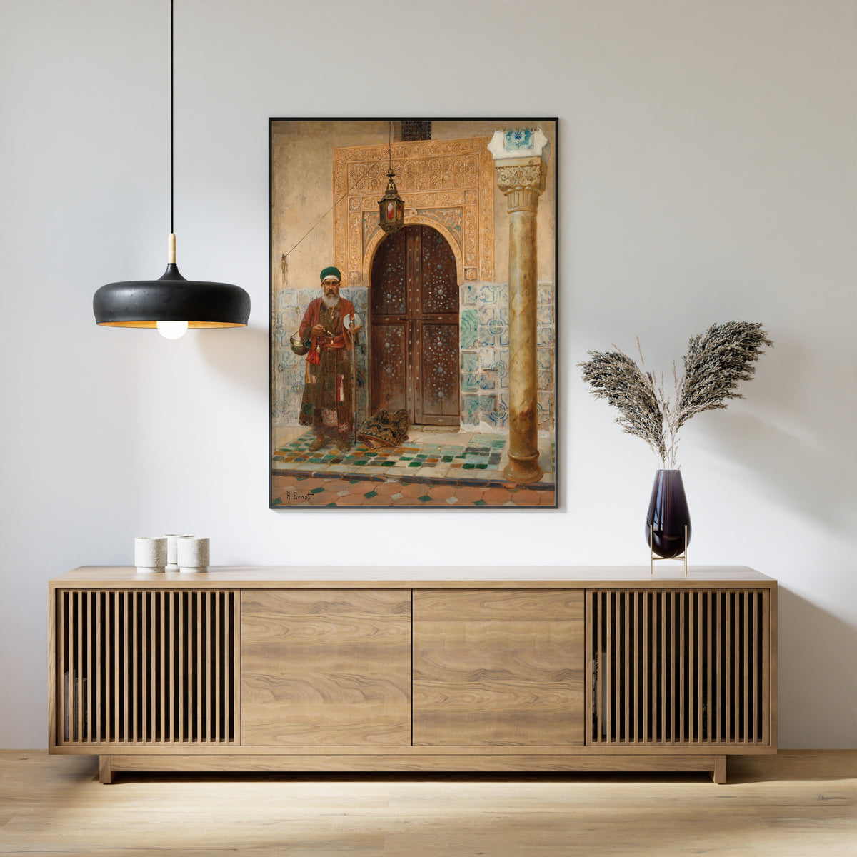 Framed art print of A holy man by an entrance by Rudolf Ernst, above a slatted wood sideboard