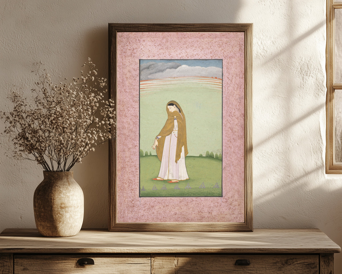 Framed art print of Abhisarika Nayika, a Heroine Longing for Her Lover by Kangra school, in a dark wood frame leaning on a rustic console beside dried flowers